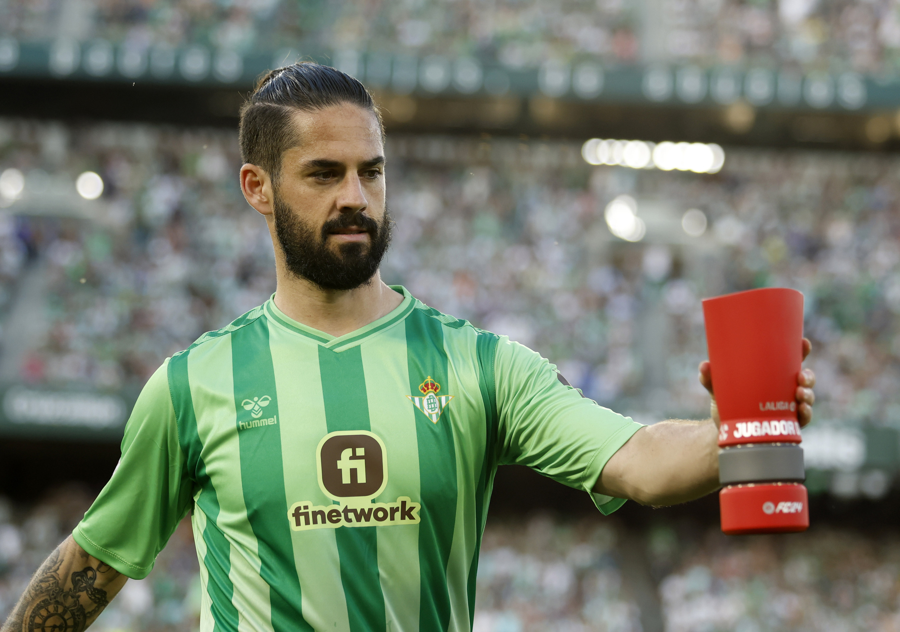 Betis?footballer Isco holds a MVP trophy of the month /