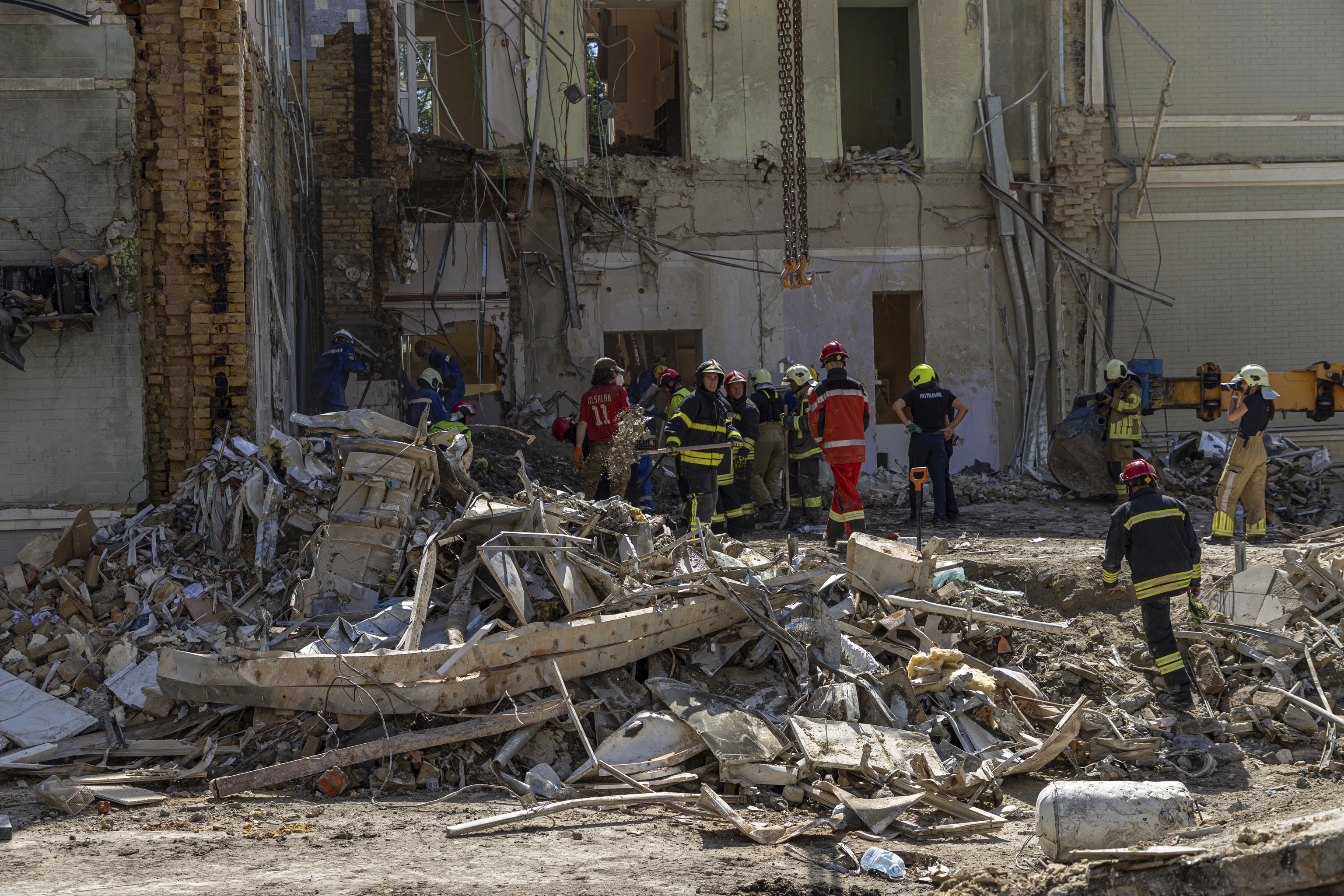 Rescue workers clear the rubble at Okhmatdyt hospital