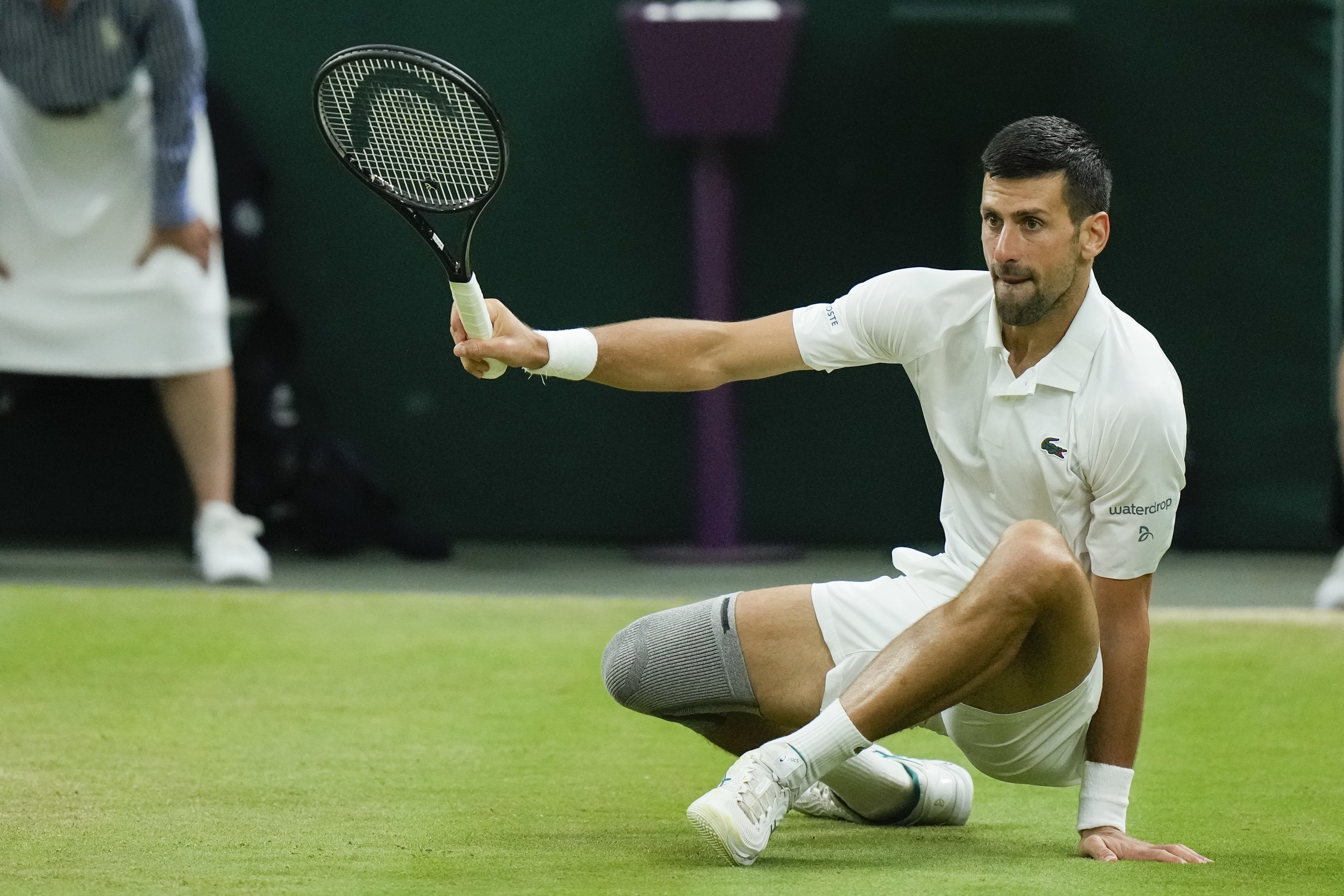 Novak Djokovic of Serbia falls during a match.