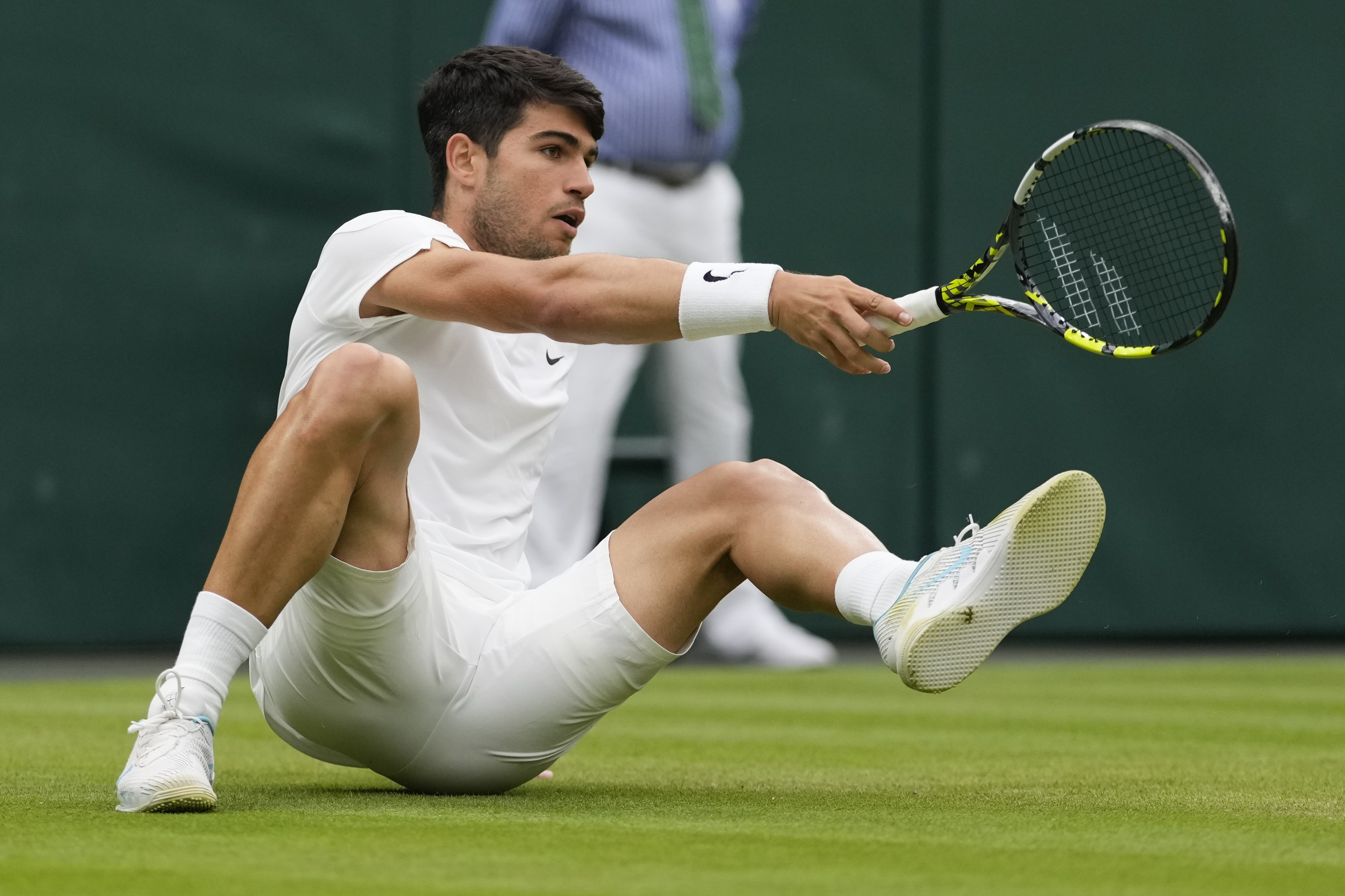 Carlos Alcaraz of Spain falls during his fourth round match against Ugo Humbert.