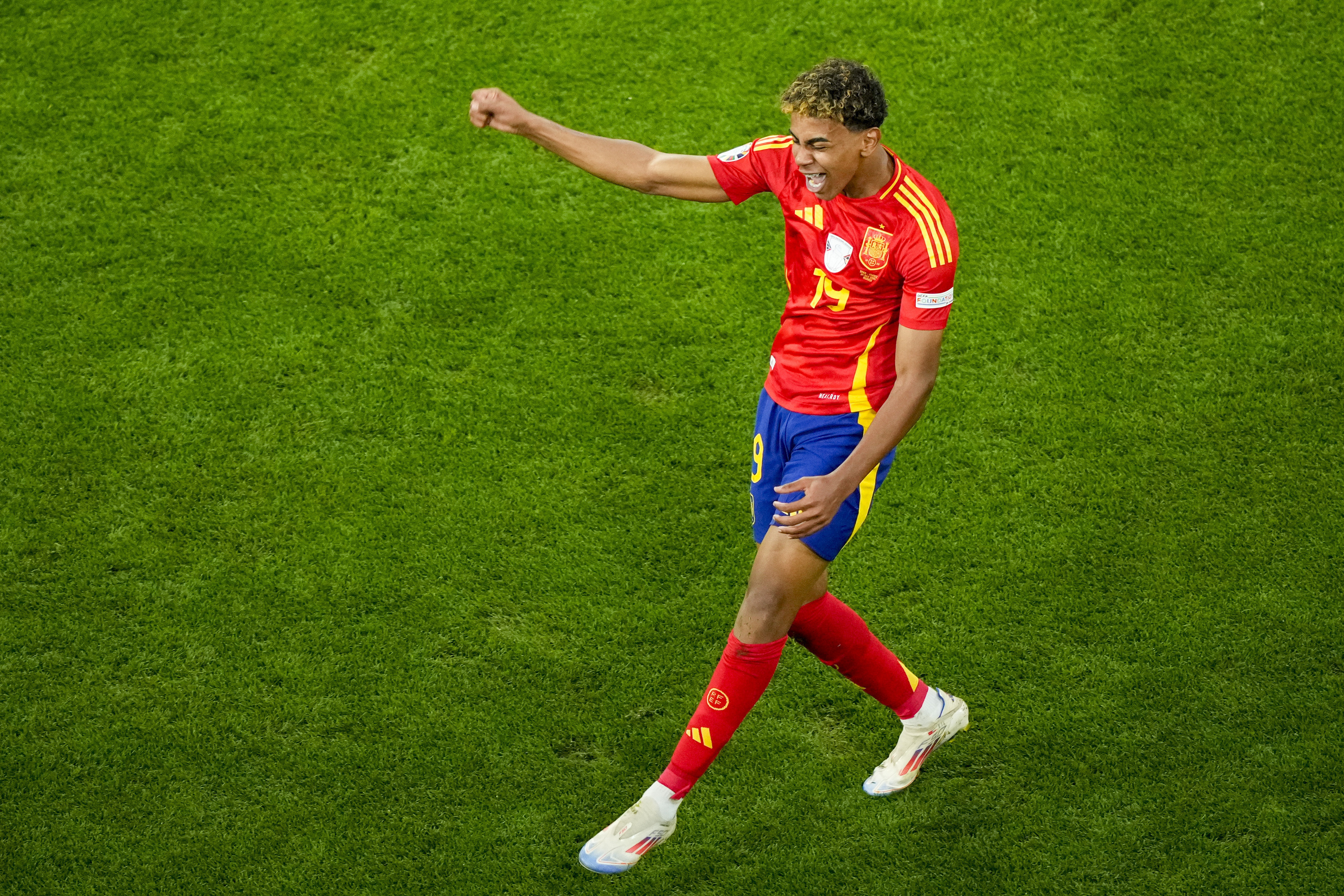 Spain's Lamine Yamal celebrates scoring his side's first goal during a semifinal match between Spain and France at the Euro 2024.