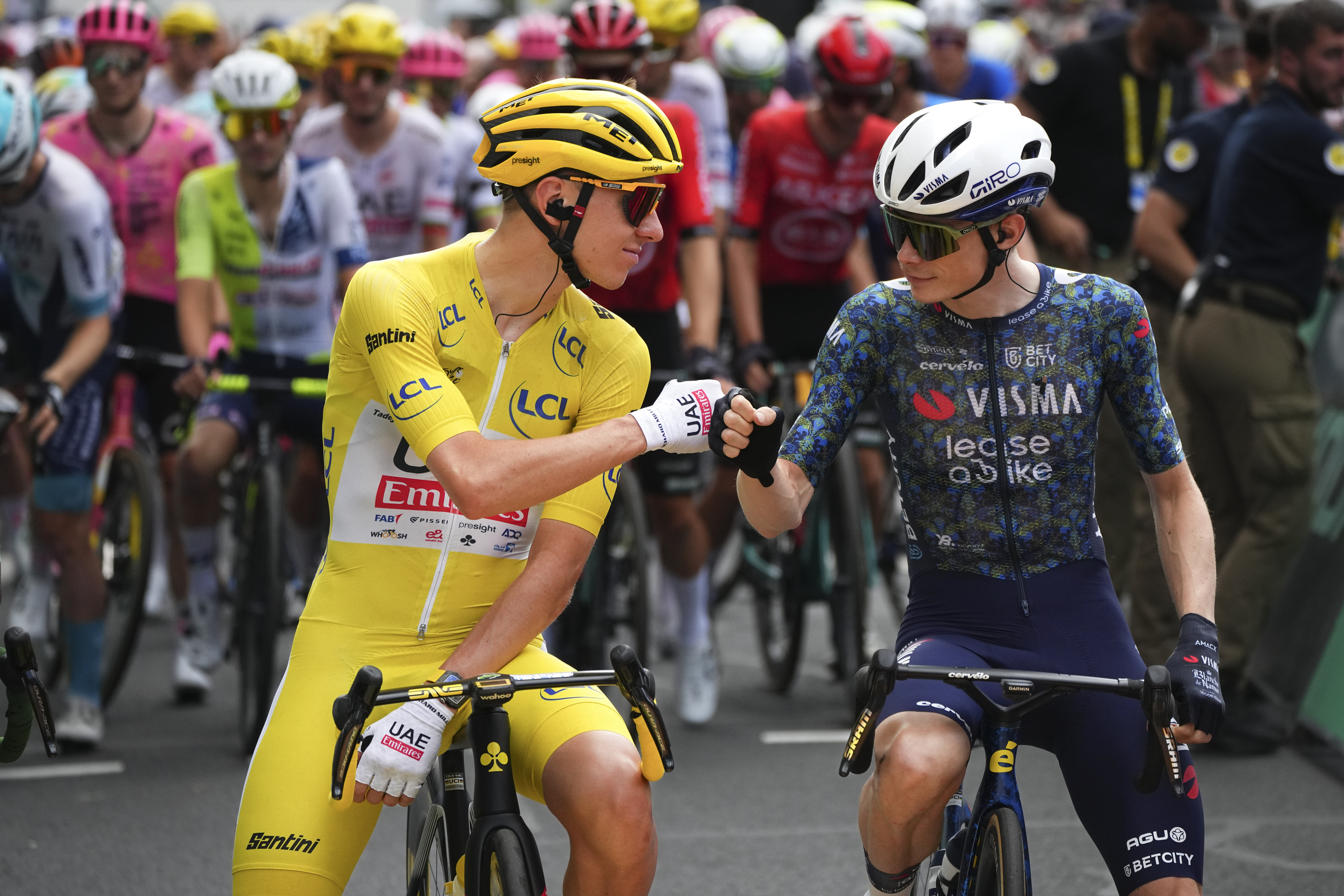 Slovenia's Tadej Pogacar, wearing the overall leader's yellow jersey, and Denmark's Jonas Vingegaard.