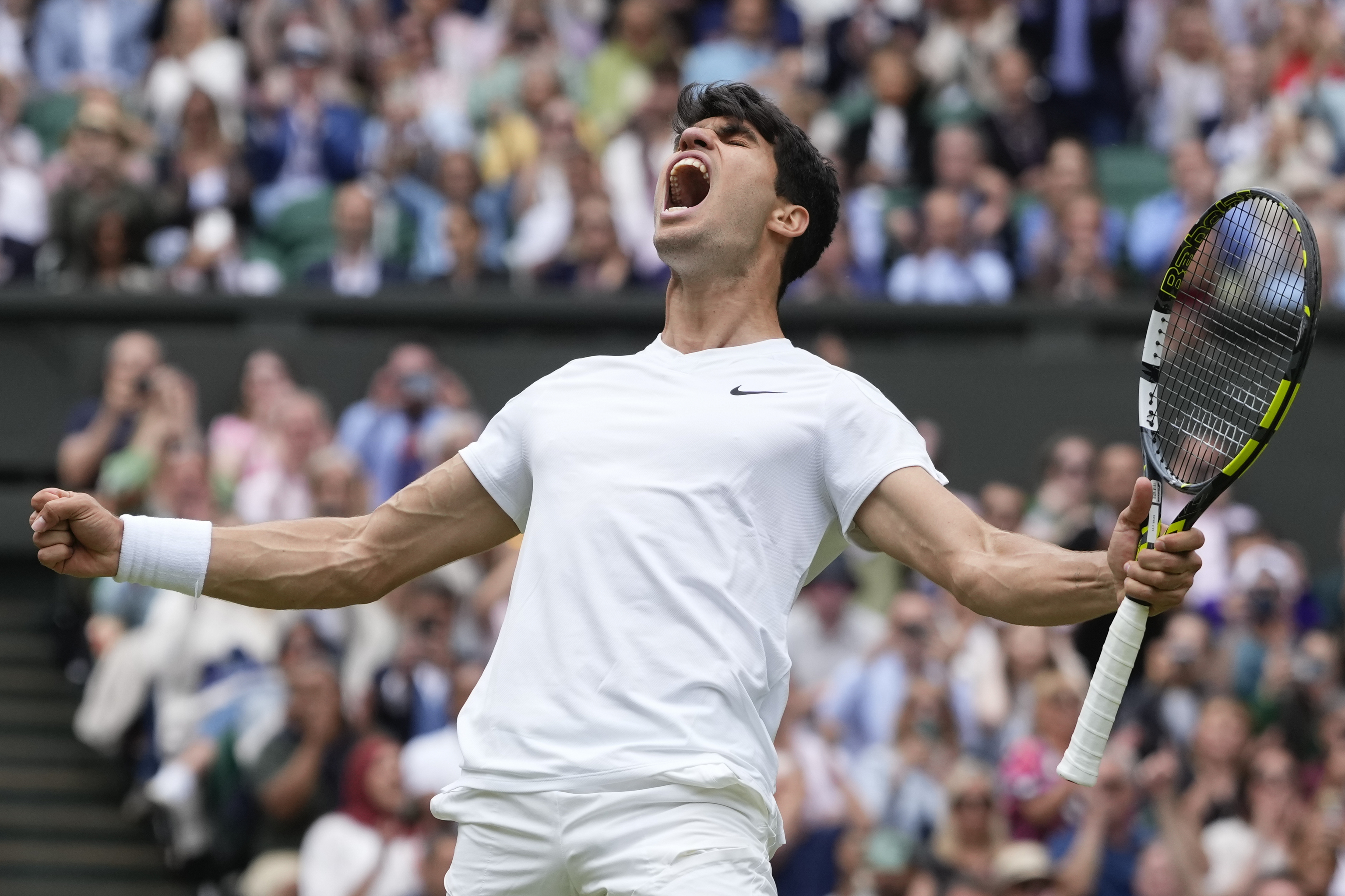 Carlos Alcaraz of Spain celebrates after defeating Daniil Medvedev.