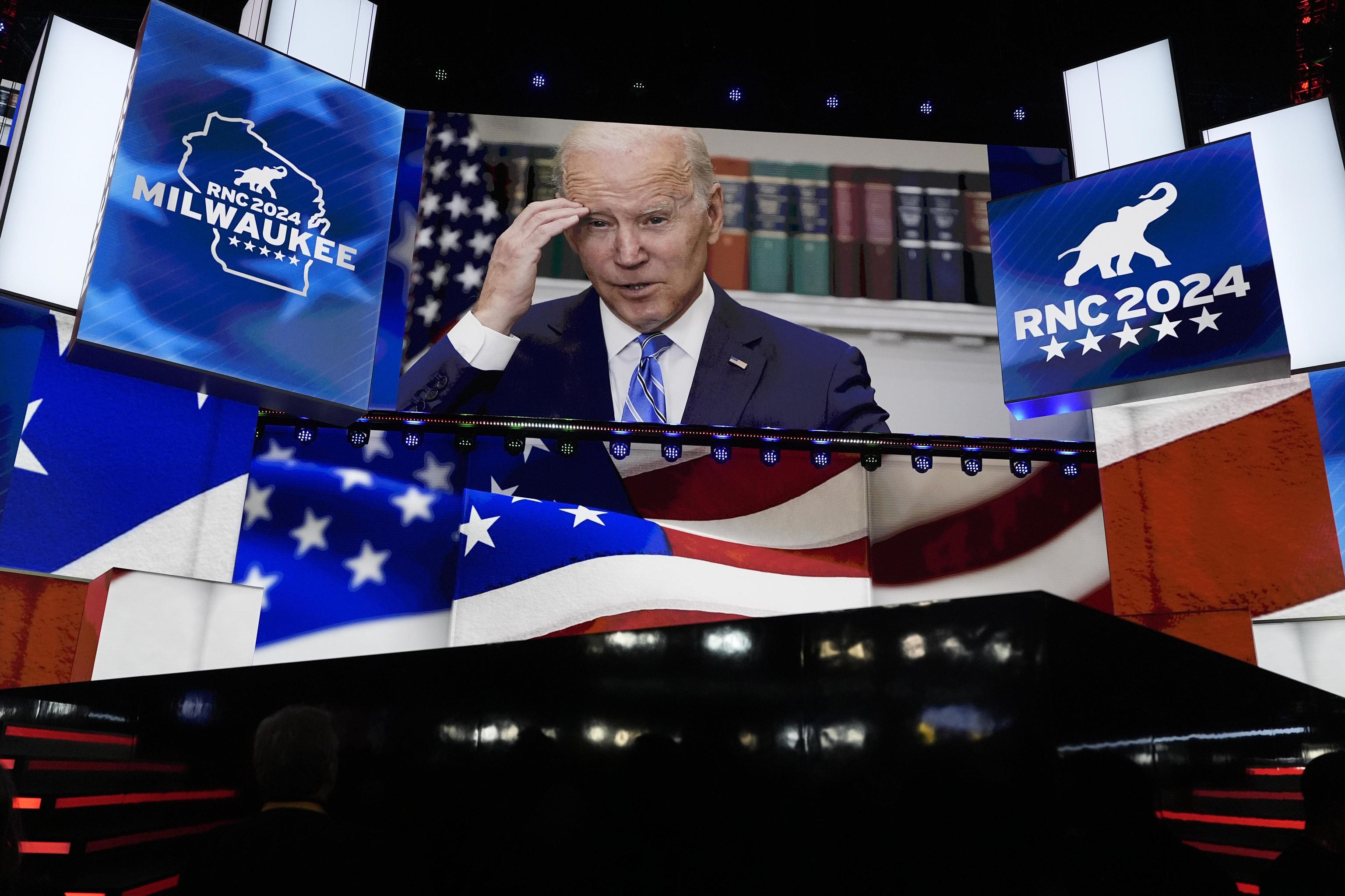 An image of President Joe Biden is projected on a screen.