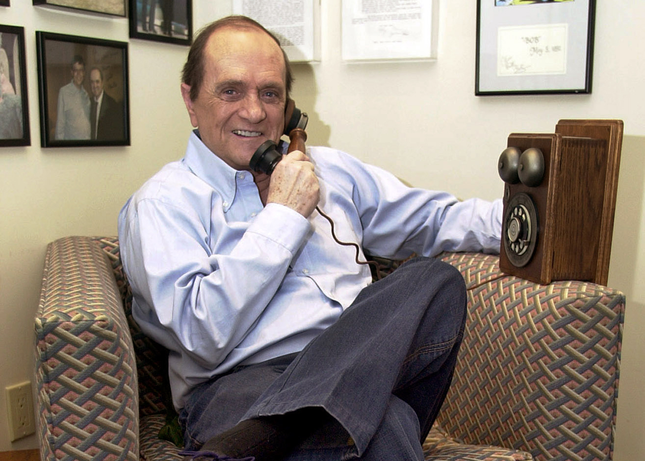 Comedian Bob Newhart pretends to speak on an antique telephone at his home in the Bel Air.