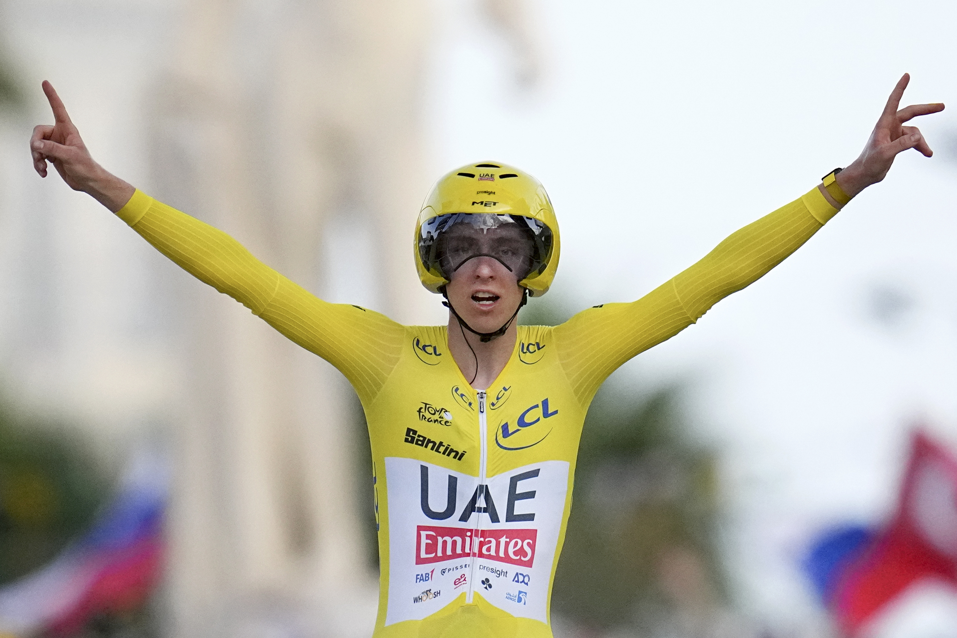 Tour de France winner Slovenia's Tadej Pogacar celebrates as he crosses the finish line.