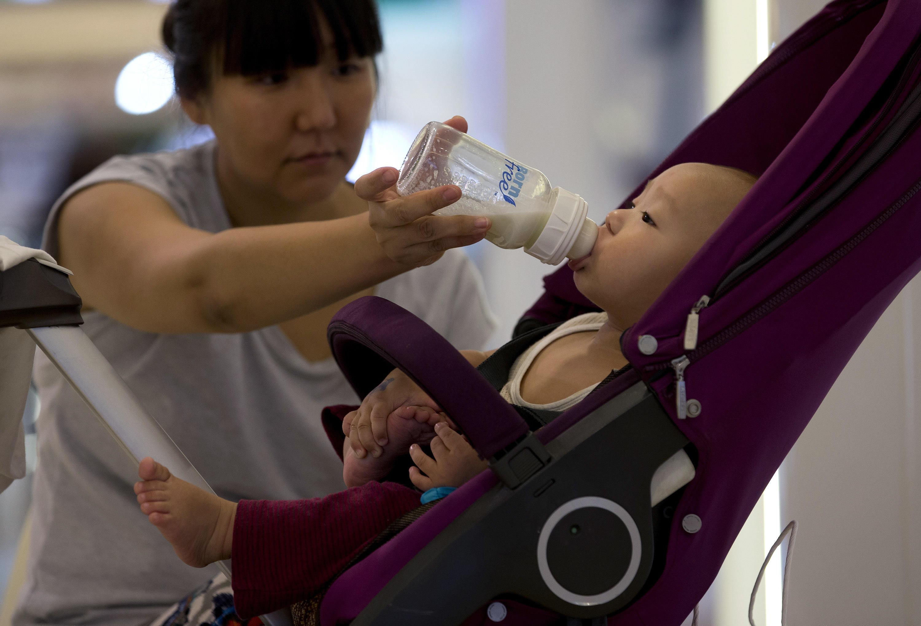 A woman feeds milk to her baby in Beijing, China.