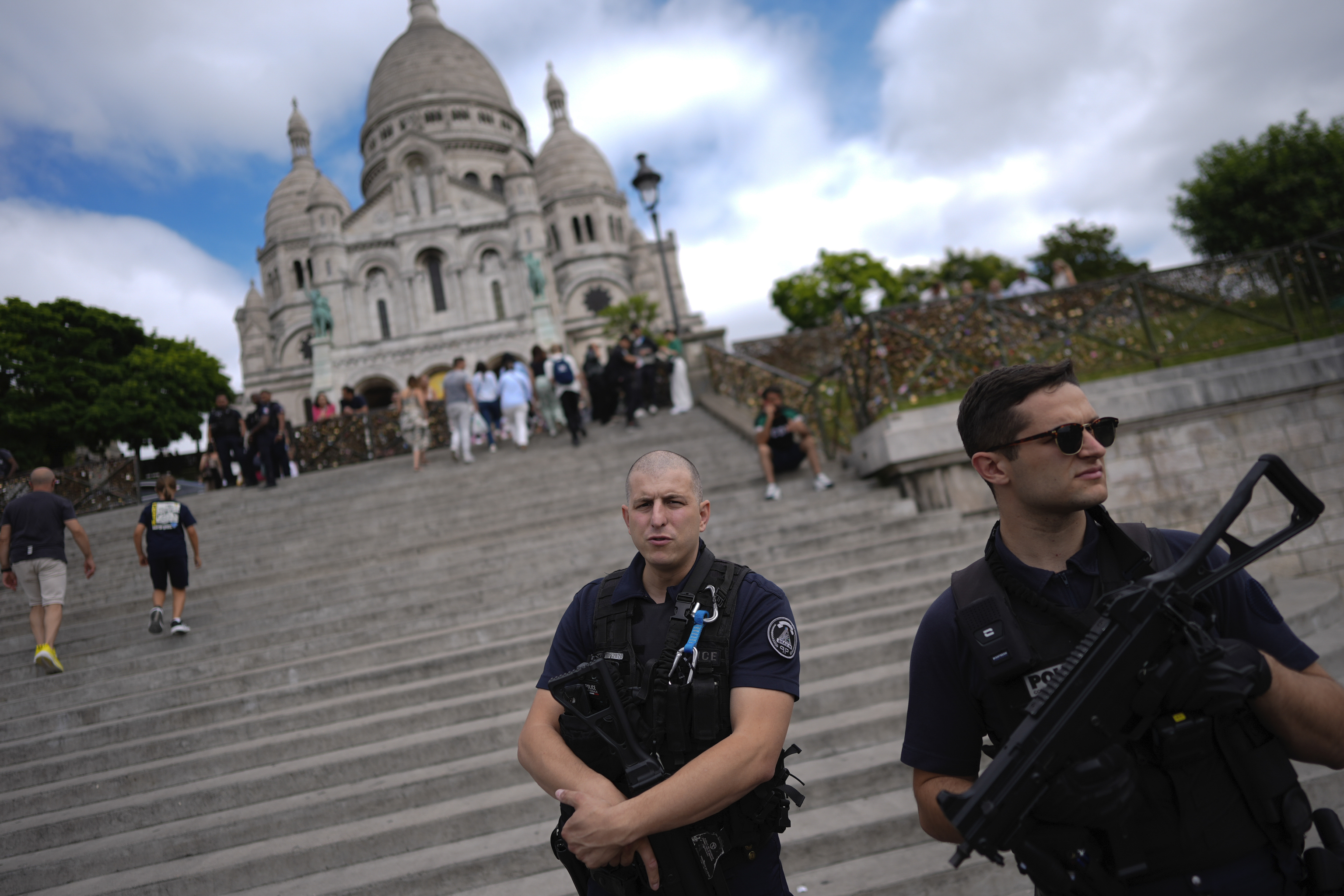 Officers from the National Police watch outside Sacre Coeur.