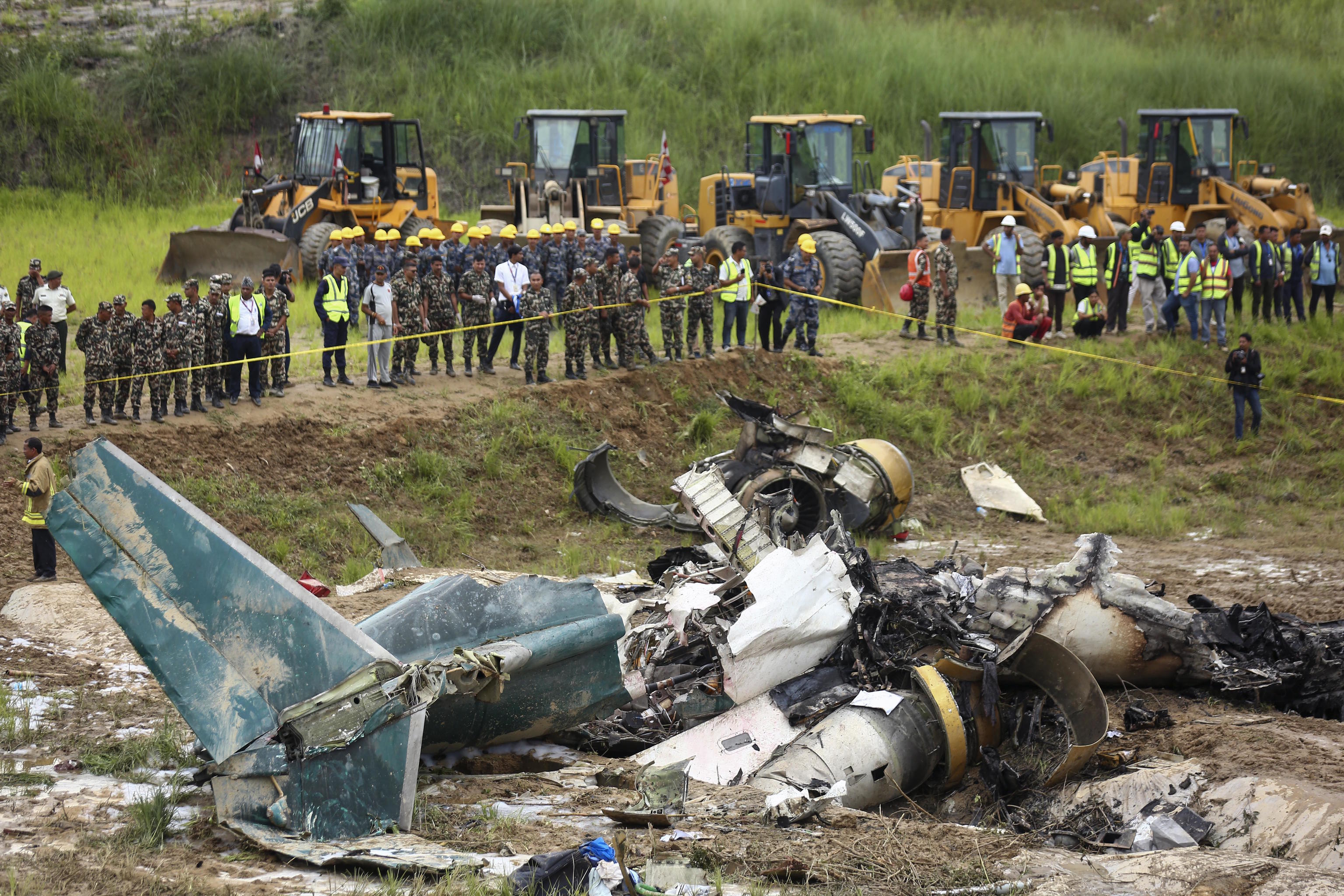 Nepal army personnel cordon off a plane crash site.