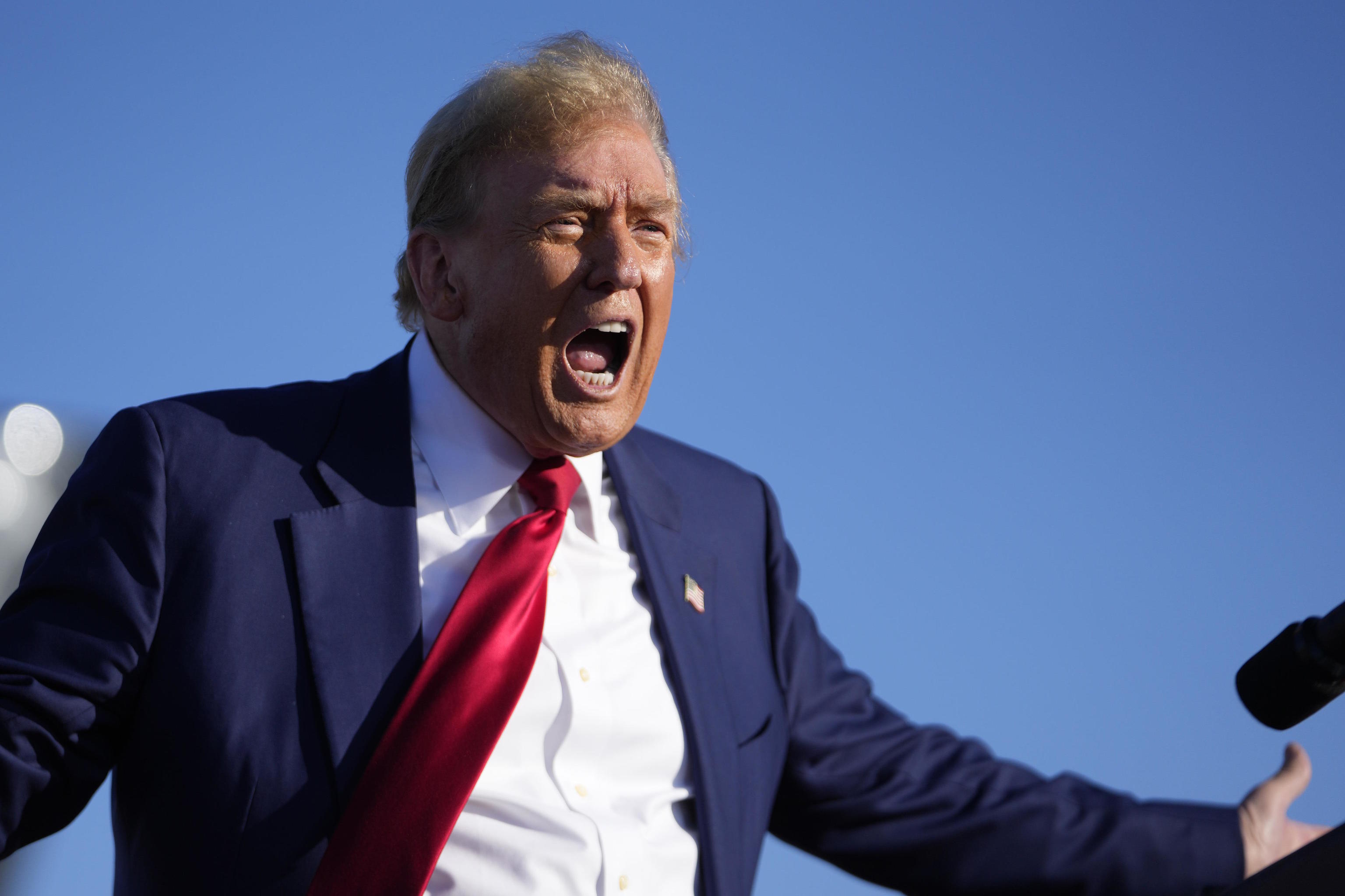 Trump reacts at a campaign rally in Freeland, Michigan.