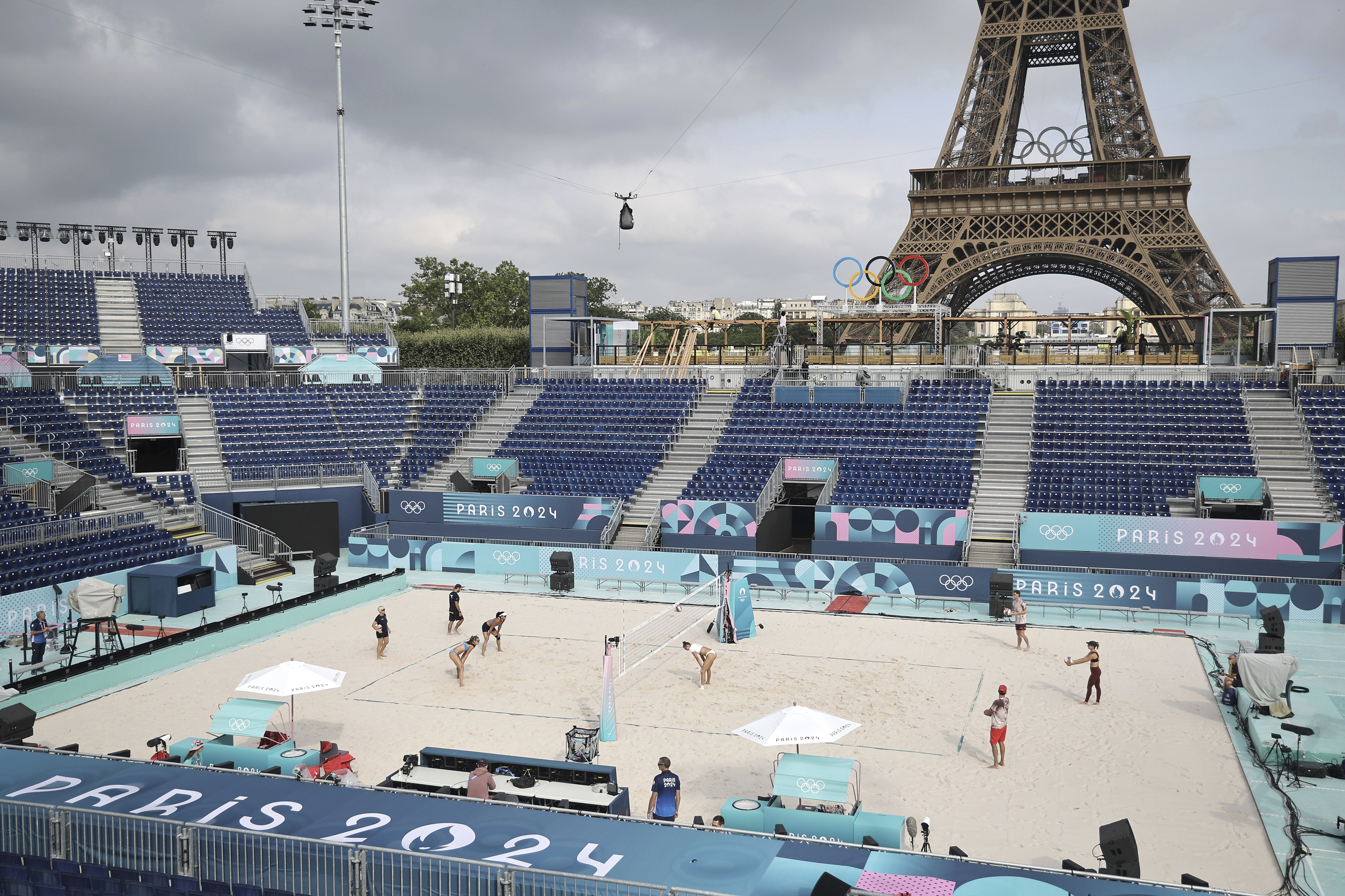 Athletes play at the Tour Eiffel Stadium that will host the Beach Volleyball.