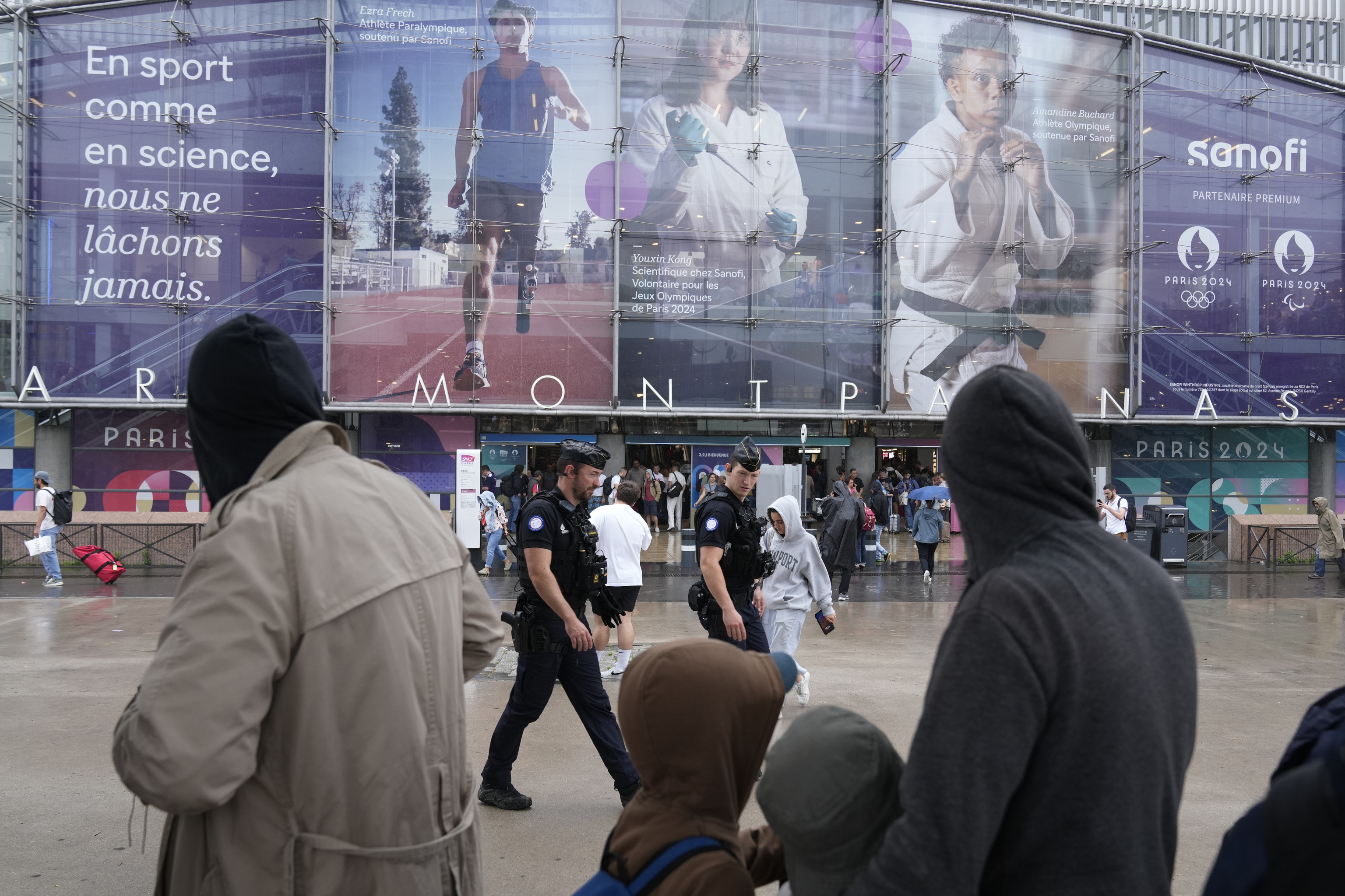 Police officers patrol outside the Gare de Montparnasse train station.