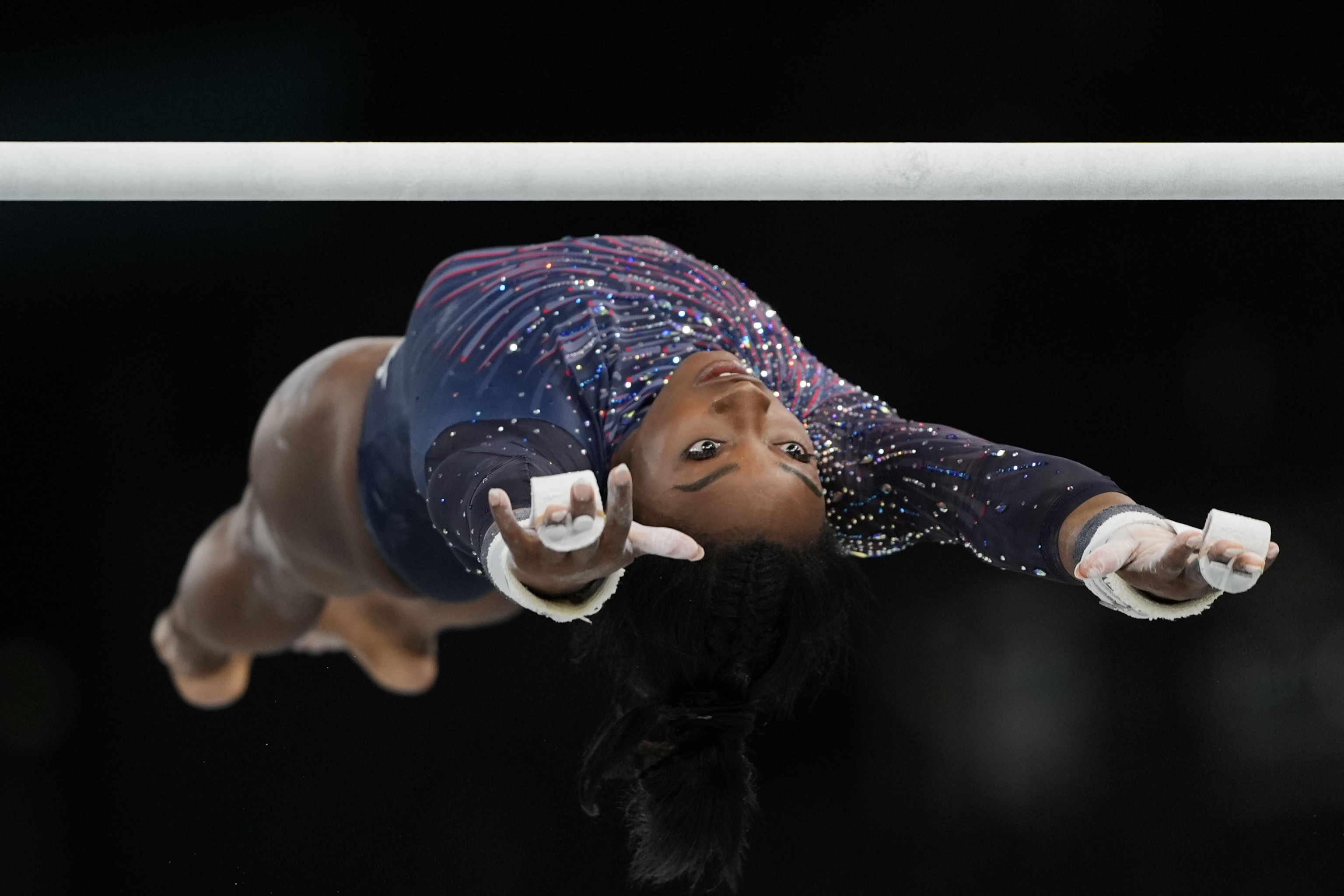 Simone Biles of the United States practices the uneven bars during a gymnastics training session at Bercy Arena.