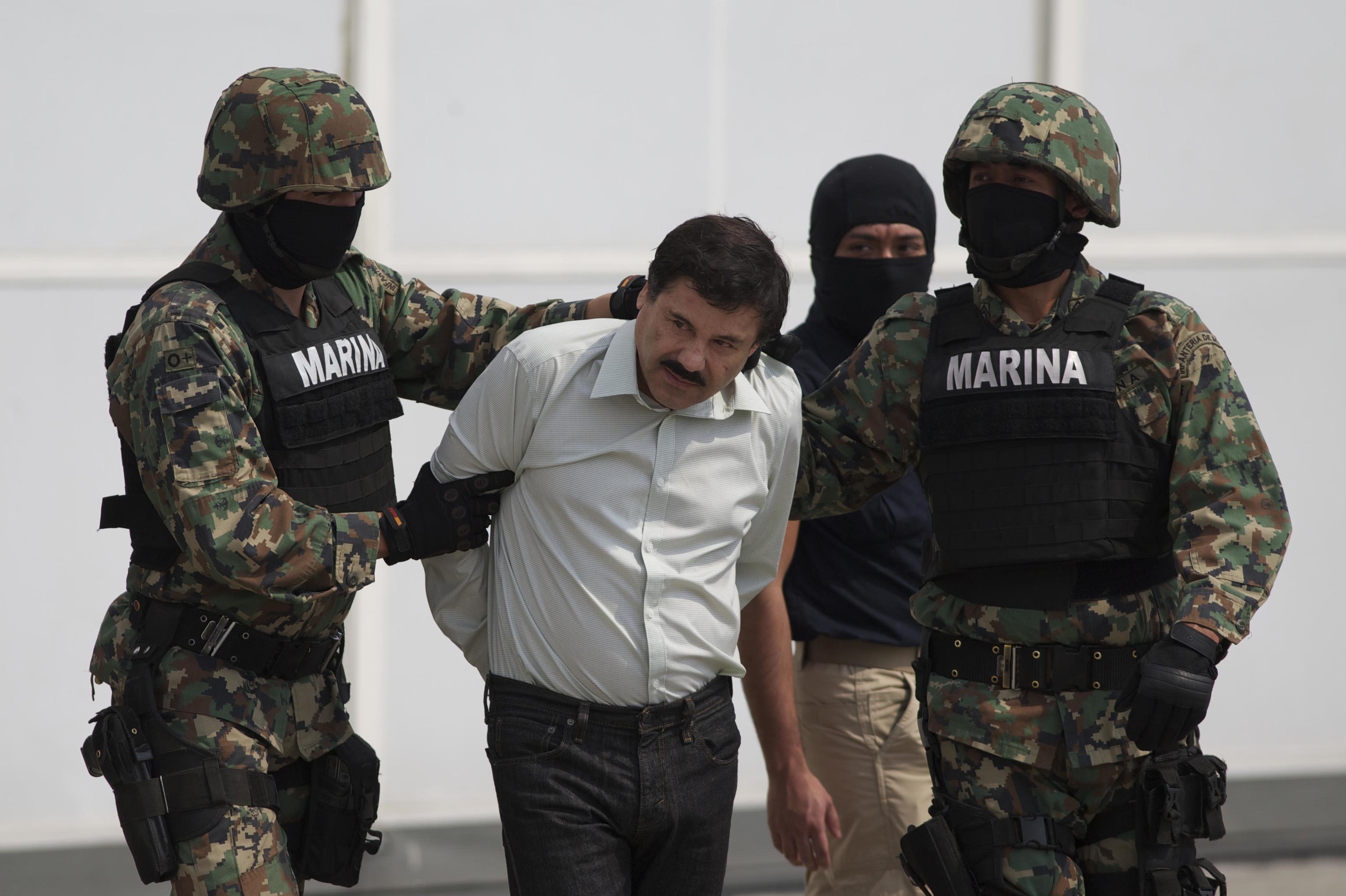 Joaquin "El Chapo" Guzman, is escorted to a helicopter.