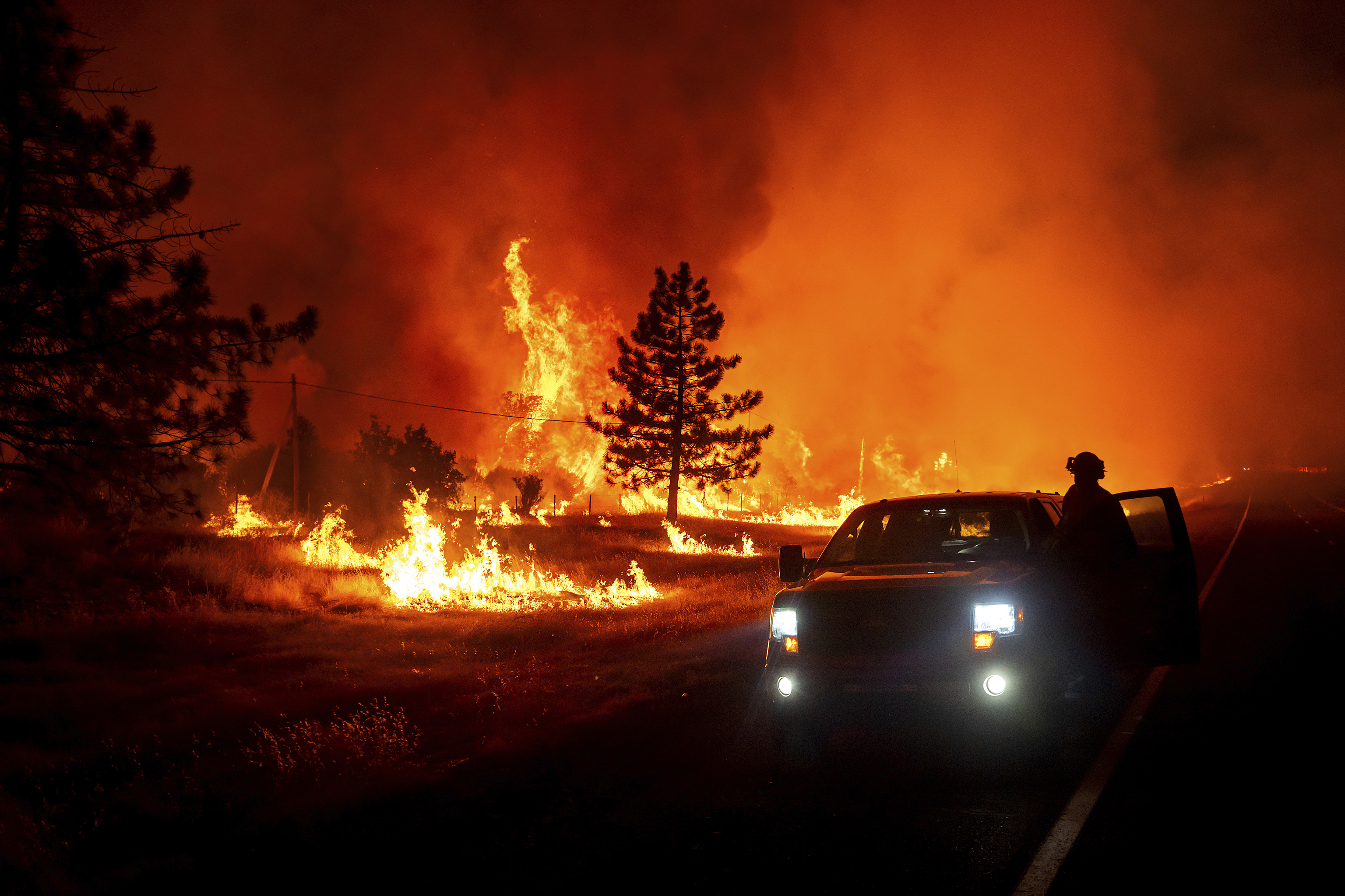 Flames burn as the Park Fire jumps Highway 36 near Paynes Creek in Tehama County, California.