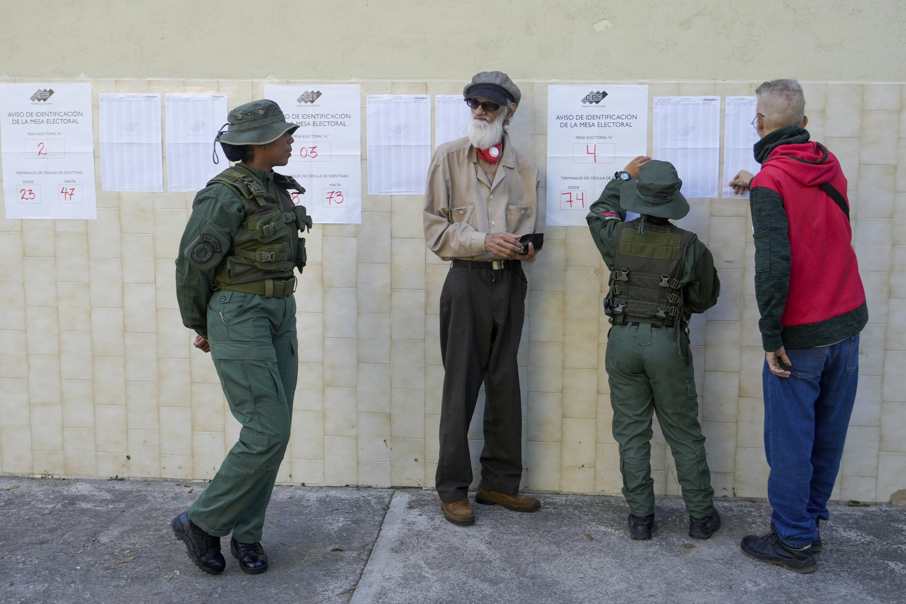 Voters look at electoral lists during presidential elections in Caracas, Venezuela.