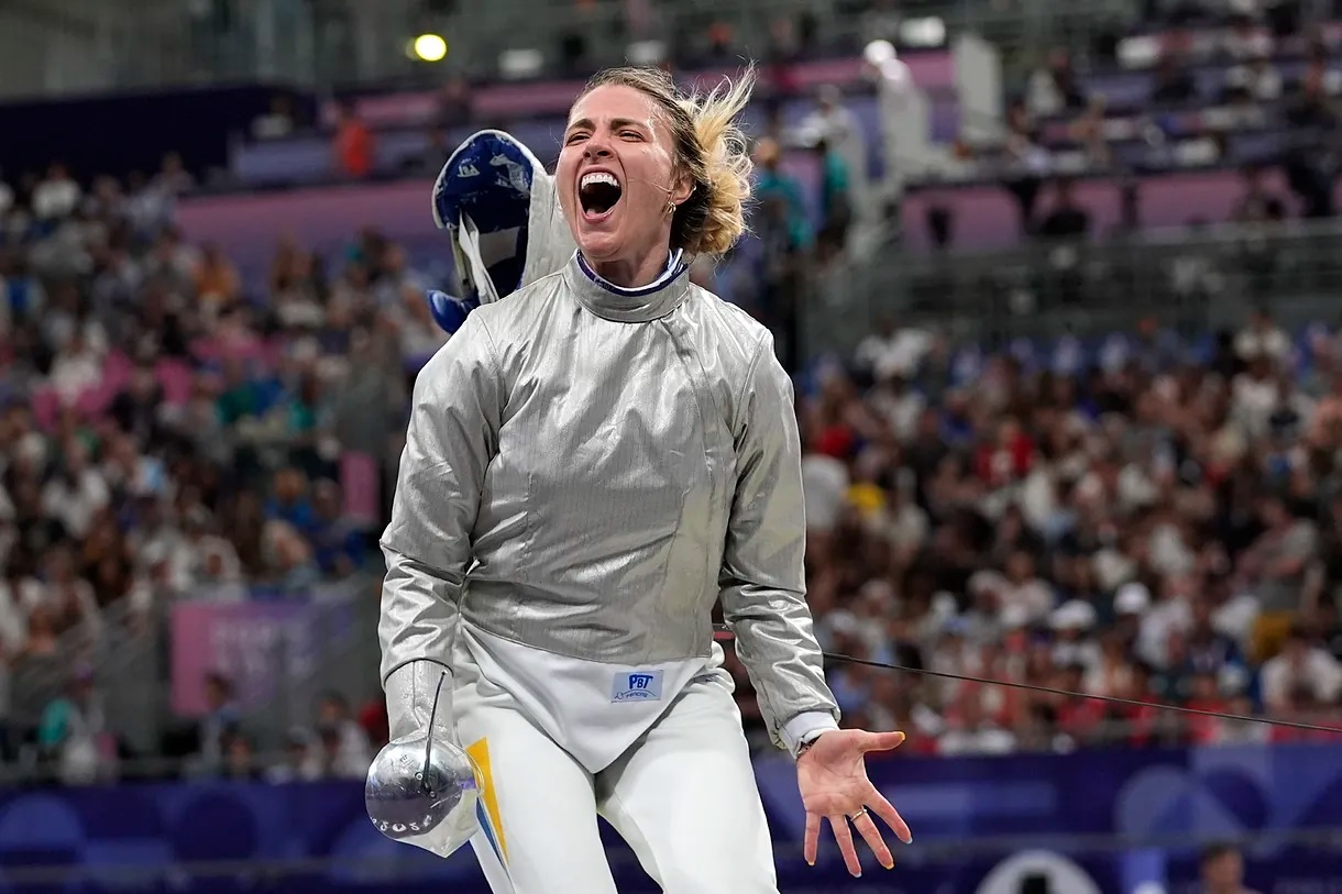 Ukrainian fencer Olga Kharlan celebrates victory against her opponent from Azerbaijan.