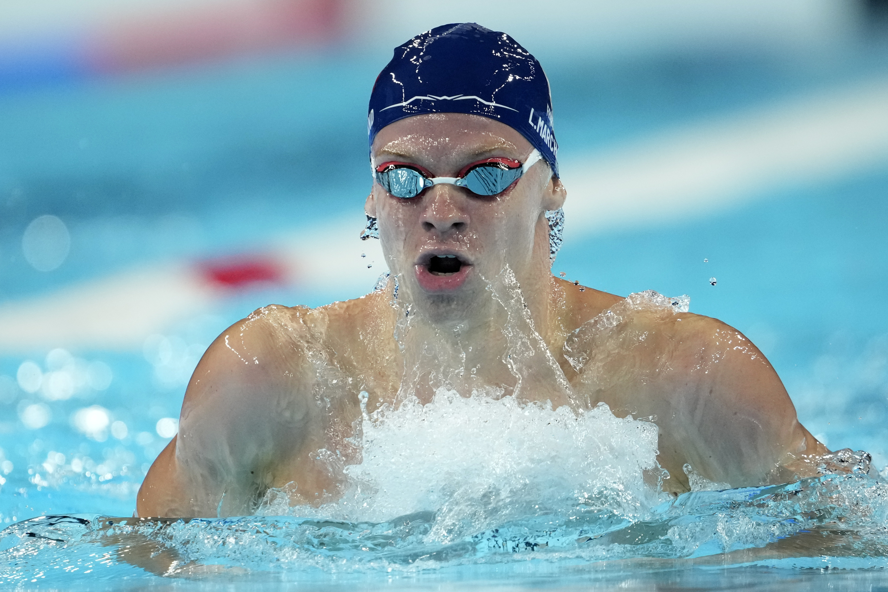 Leon Marchand, of France, competes during a heat in the men's 200-meter breaststroke at the 2024 Summer Olympics.