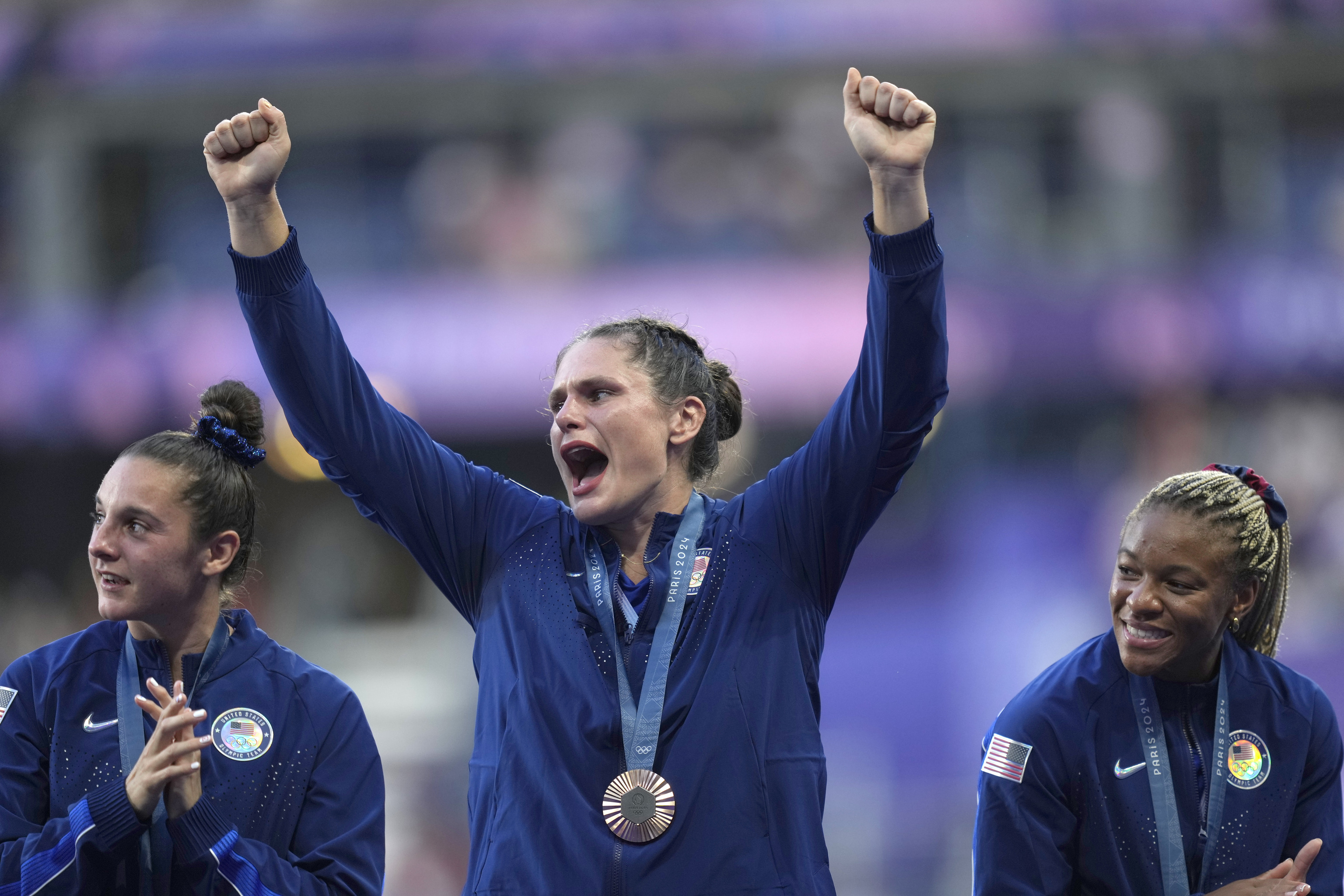 Ilona Maher reacts as she stands on the podium.