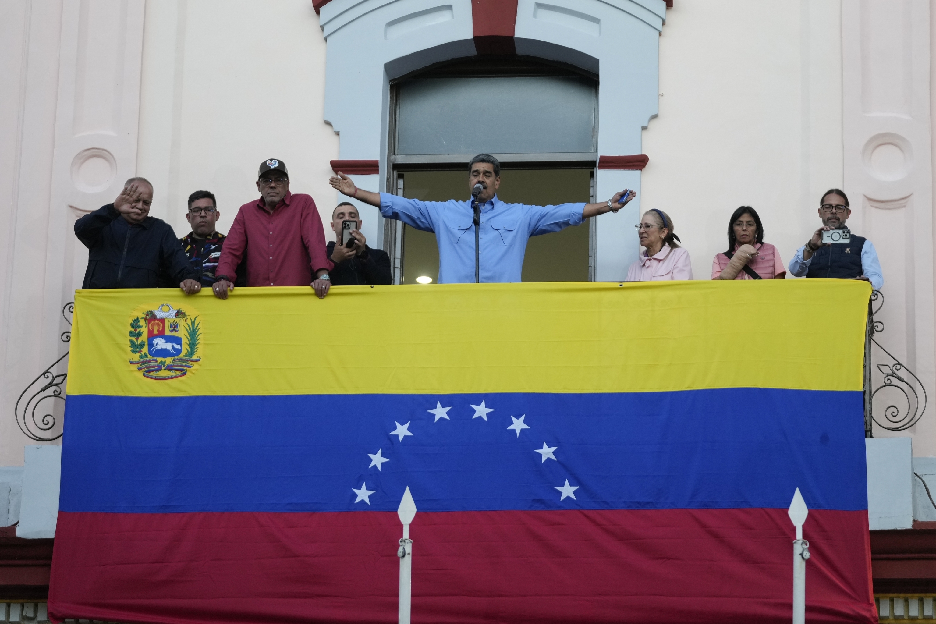 President Nicolas Maduro gestures to supporters during a speech from the presidential palace.