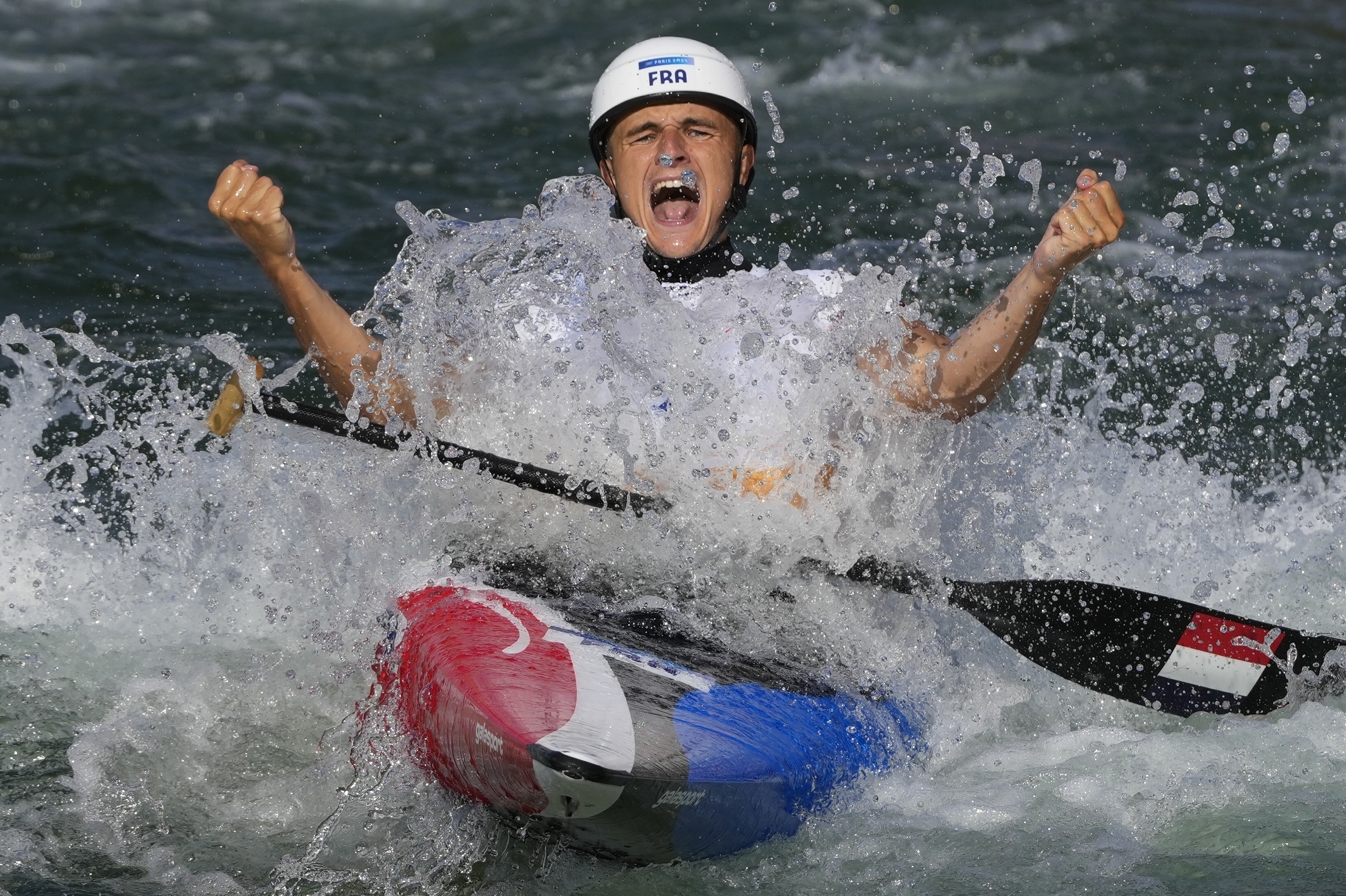 Nicolas Gestin reacts at the finish line of the men's canoe.