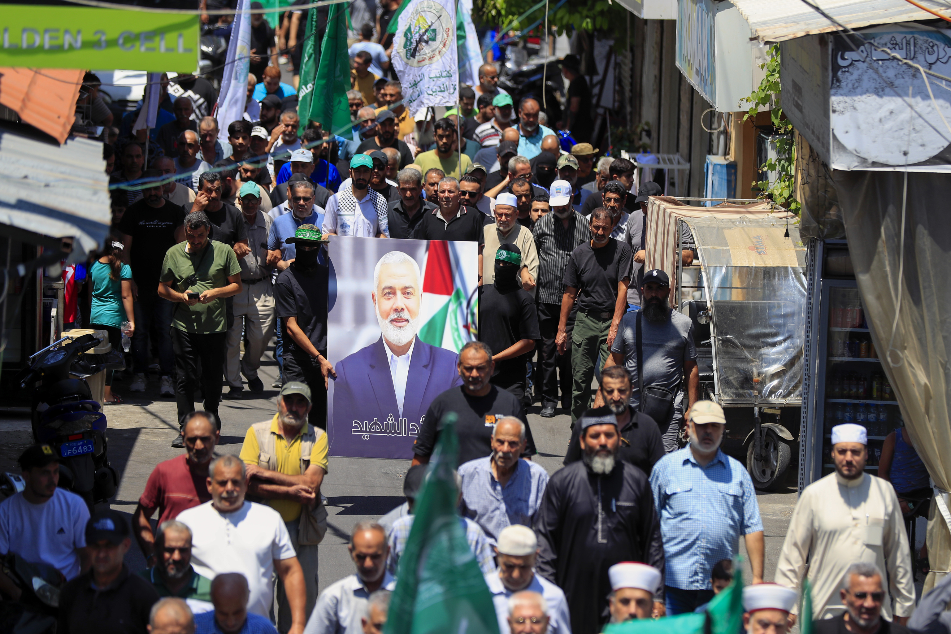 Hamas members hold a portrait of Hamas political chief Ismail Haniyeh.