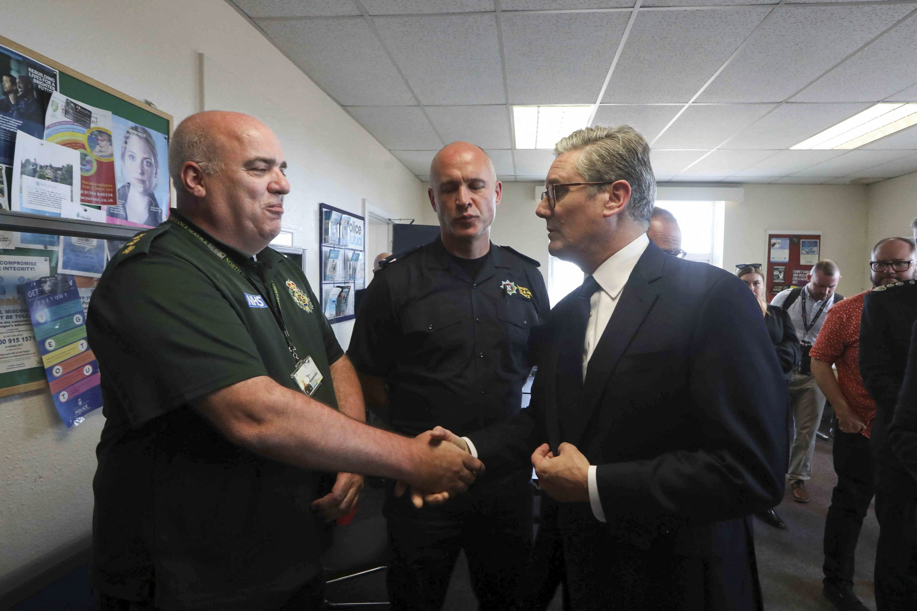 British Prime Minister Keir Starmer speaks to a member of the emergency personnel following a knife attack in which children were killed.