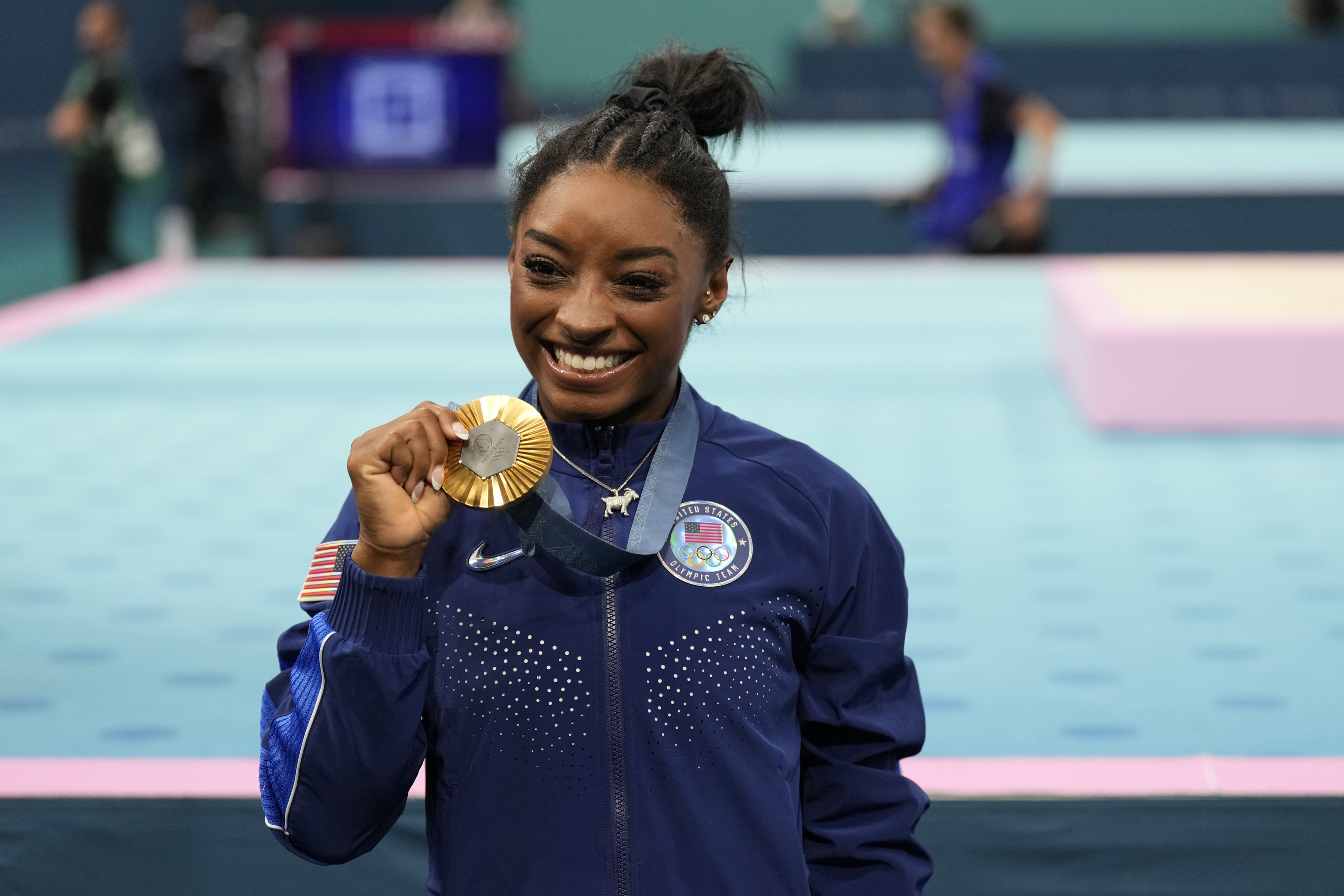 Simone Biles, of the United States, celebrates after winning the gold medal.