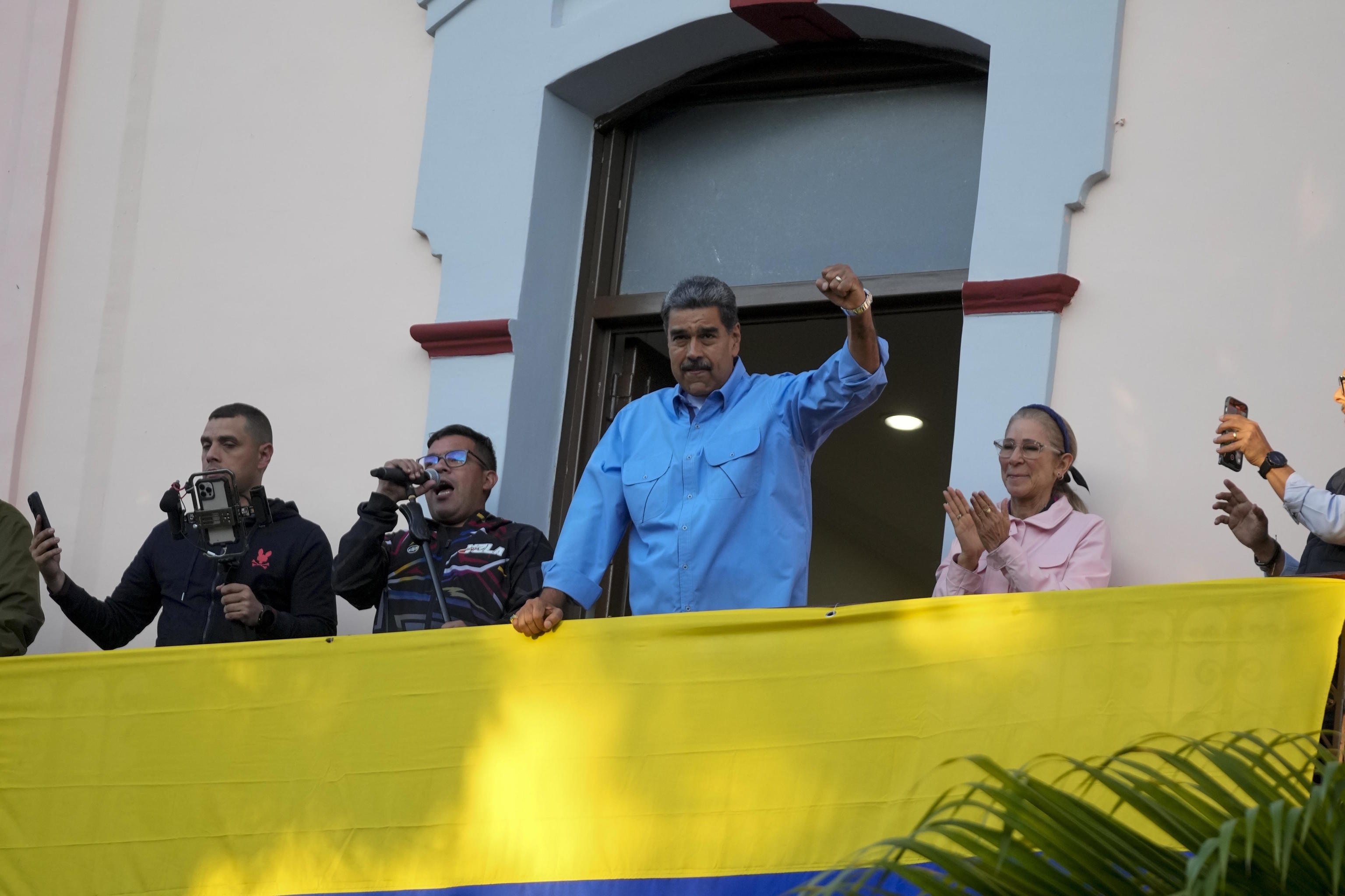 Maduro gestures to supporters.