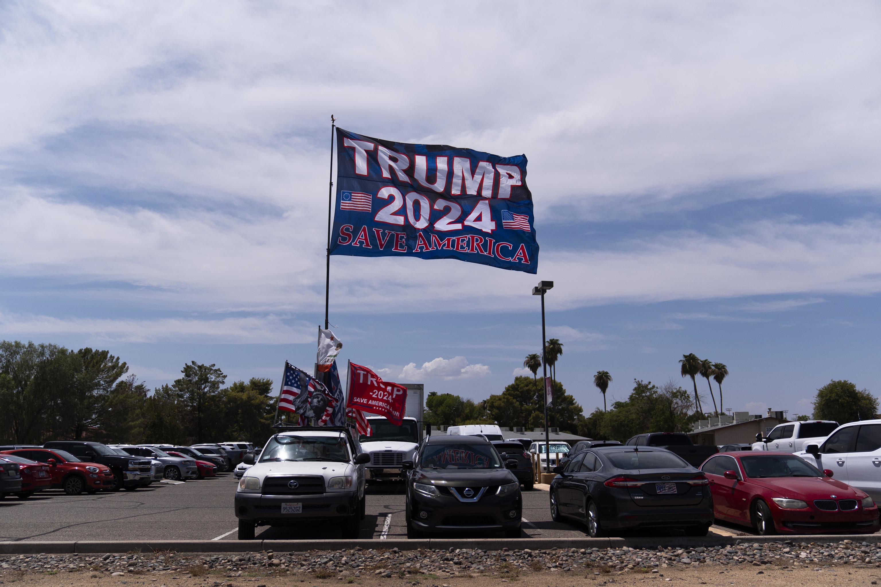 A pickup truck with flags supporting Donald Trump.