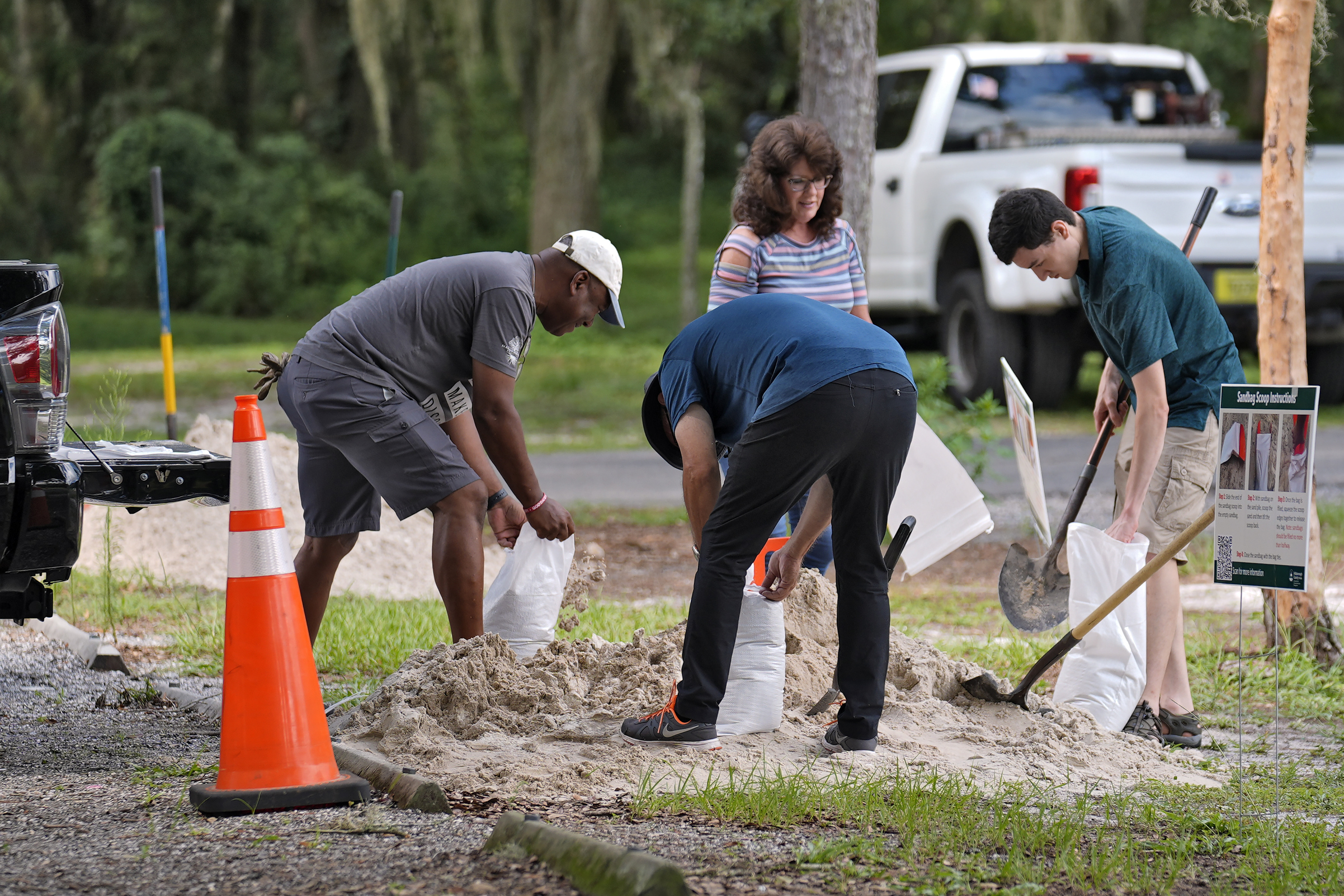 Residents fill sand bags at the Edward Medard Conservation Park in preparation for a weekend storm.