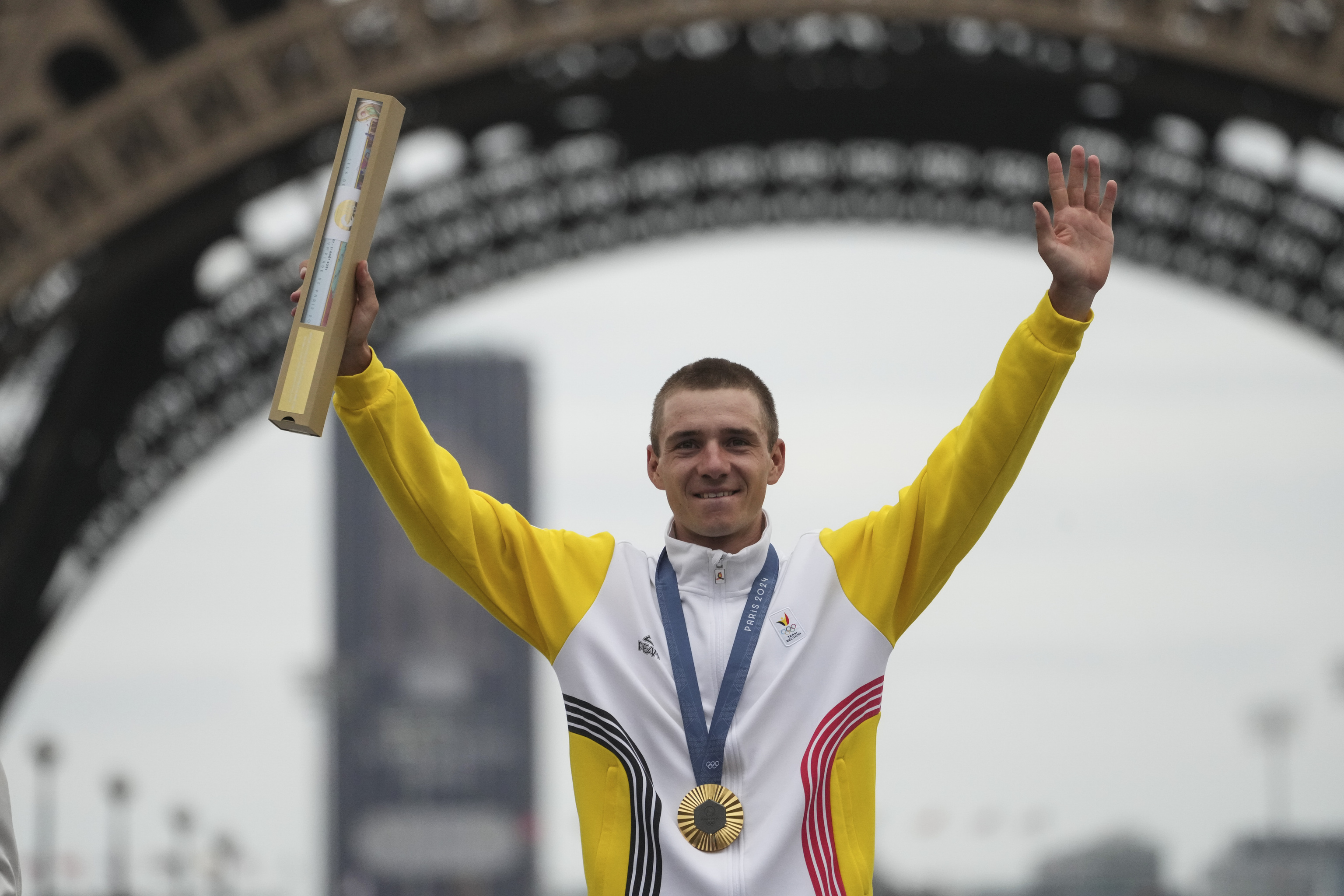 Remco Evenepoel, of Belgium, poses with the gold medal of the men's road cycling event.