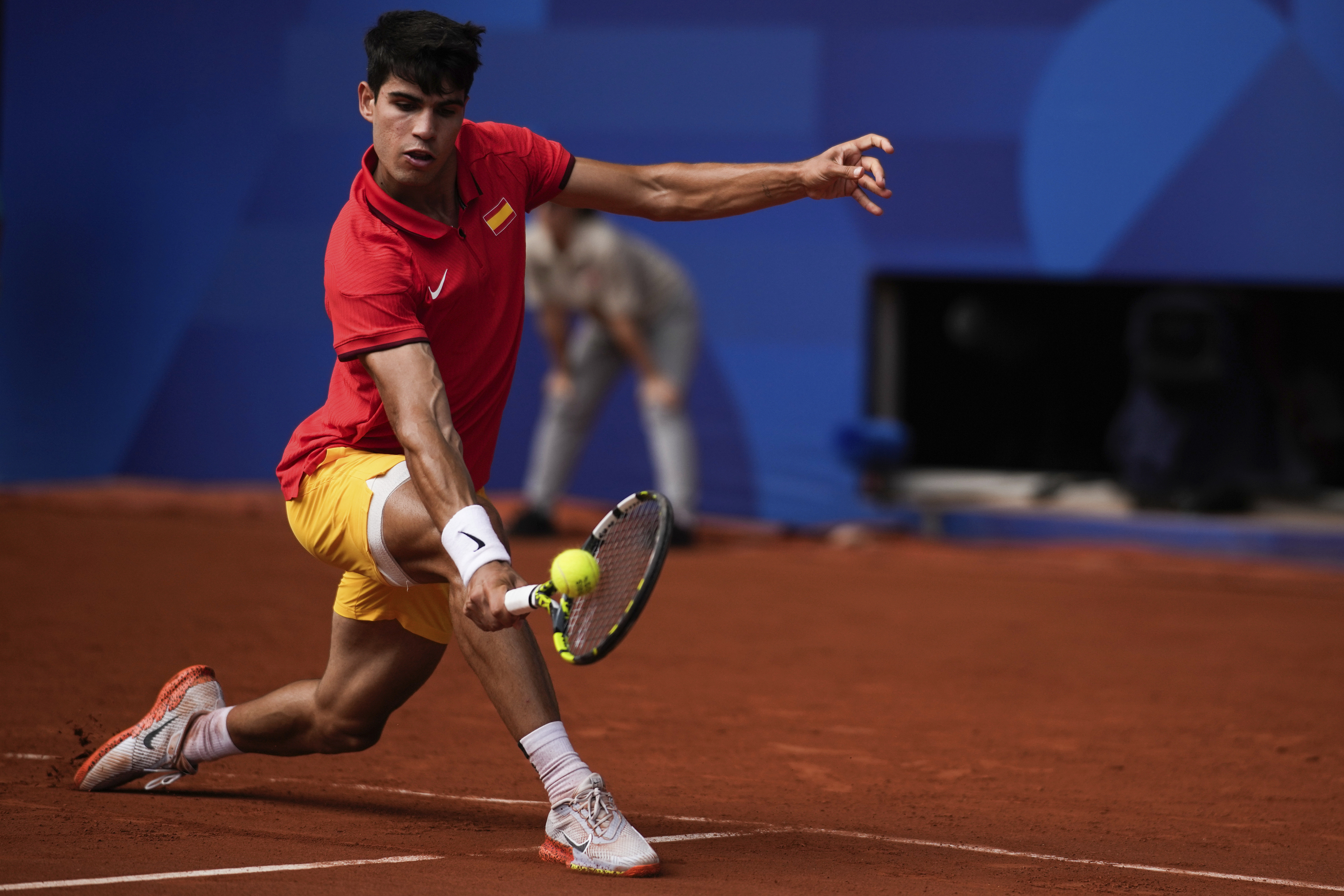 Spain's Carlos Alcaraz backhands to Serbia's Novak Djokovic.