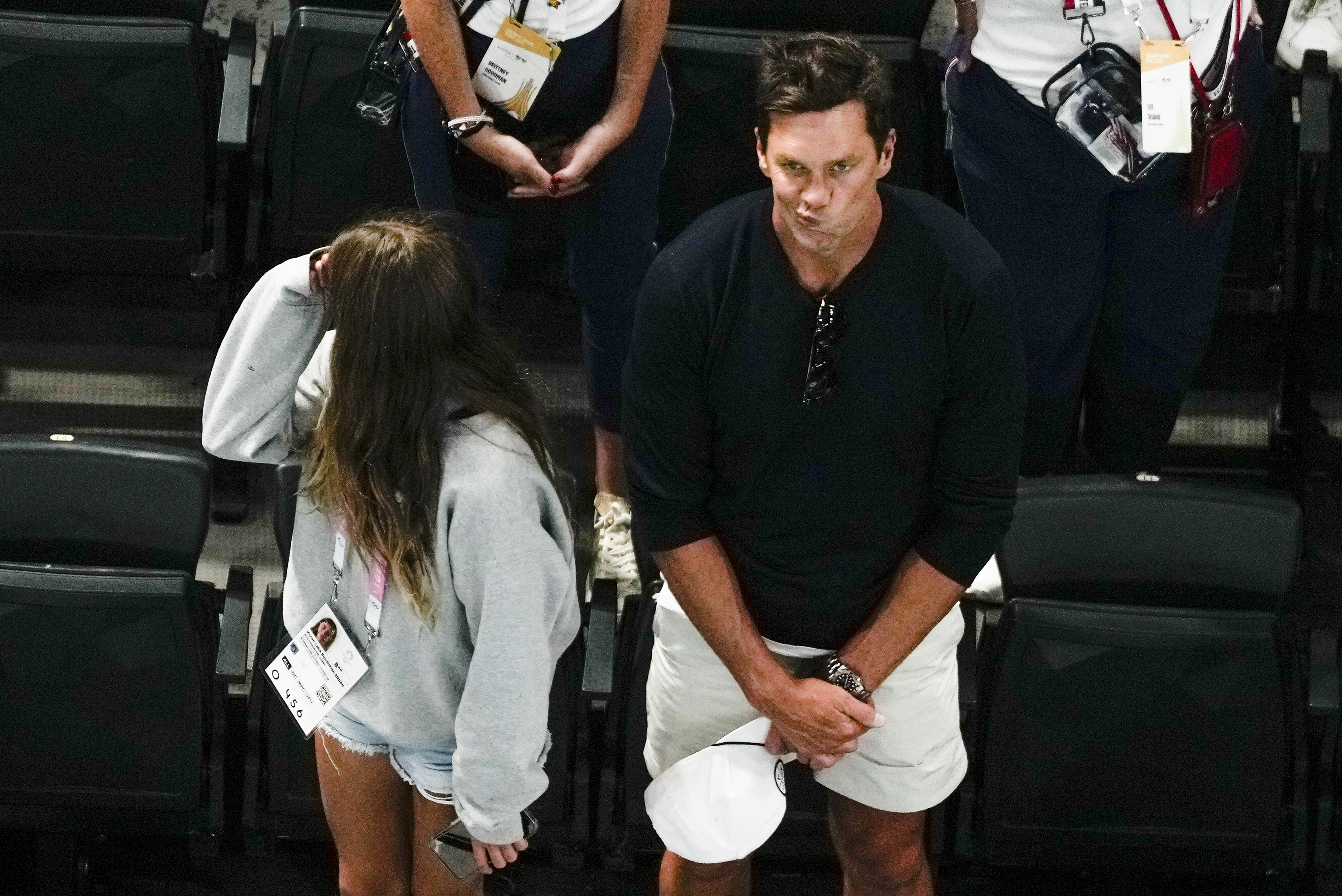 Tom Brady watches the end of the women's artistic gymnastics individual.