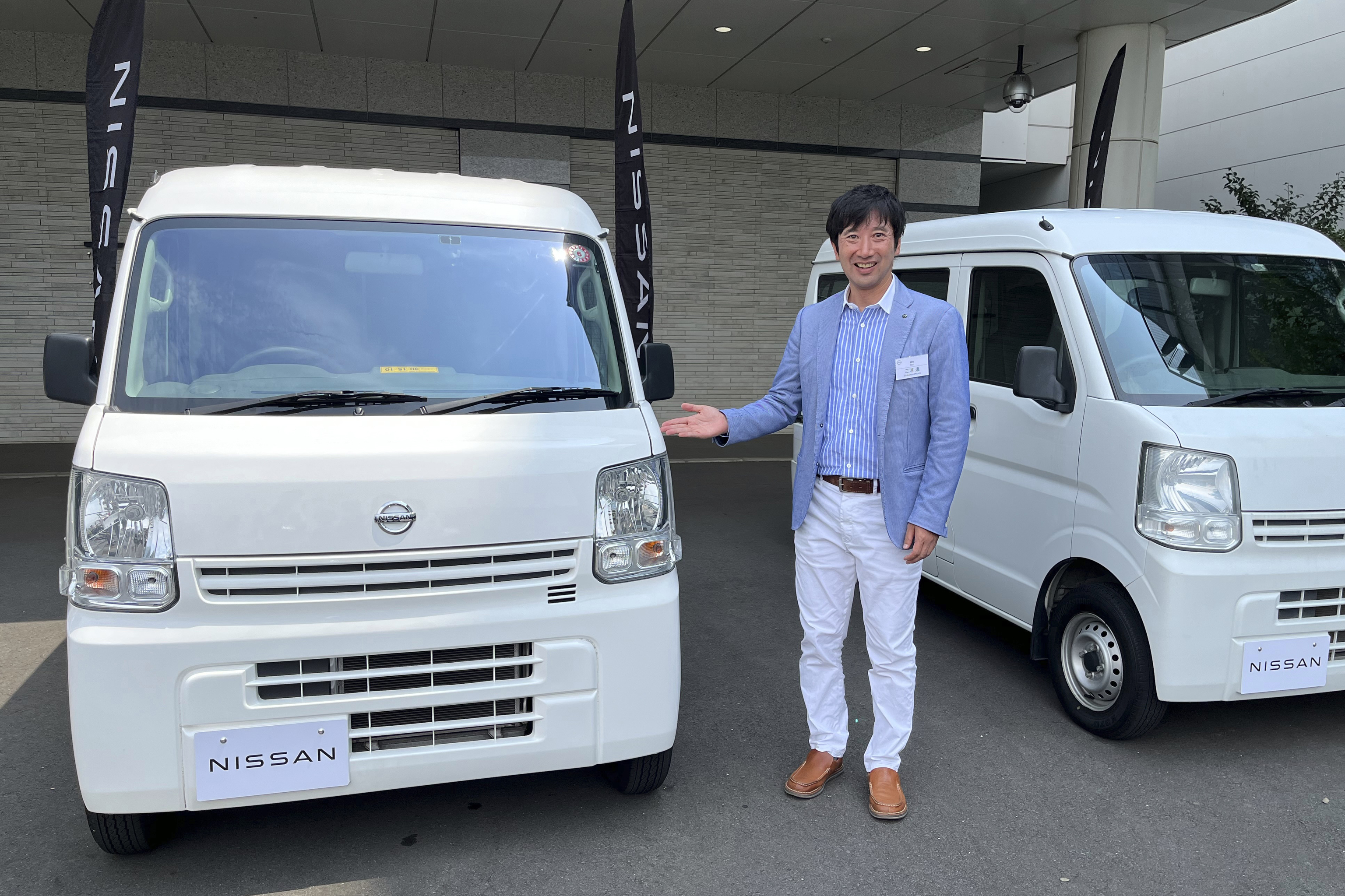 Susumu Miura, a Nissan Research Center manager, shows a Nissan car that is coated with the special 'cool paint'