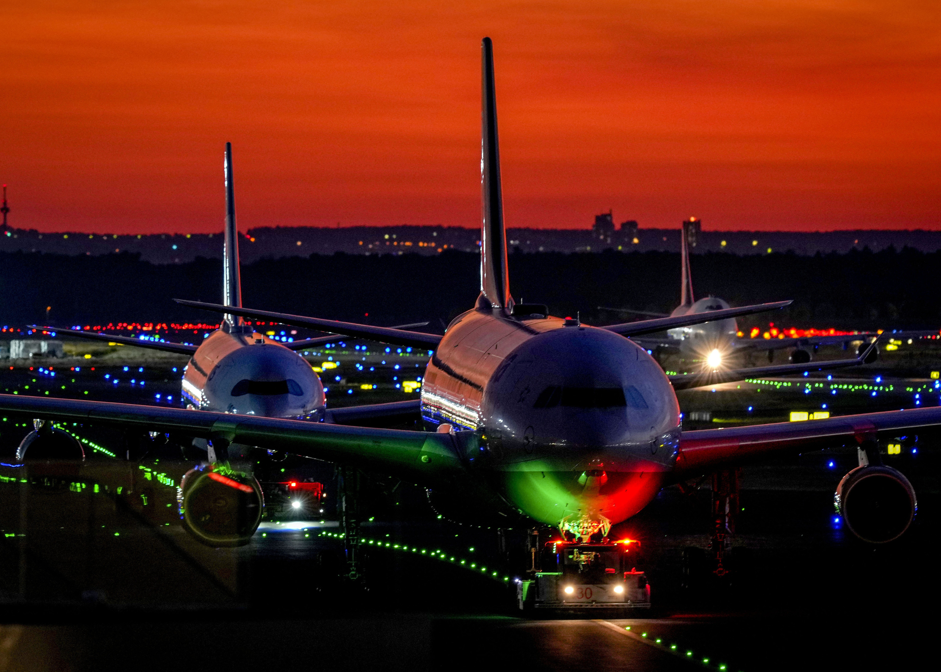 Aircrafts roll over a runway at the airport in Frankfurt