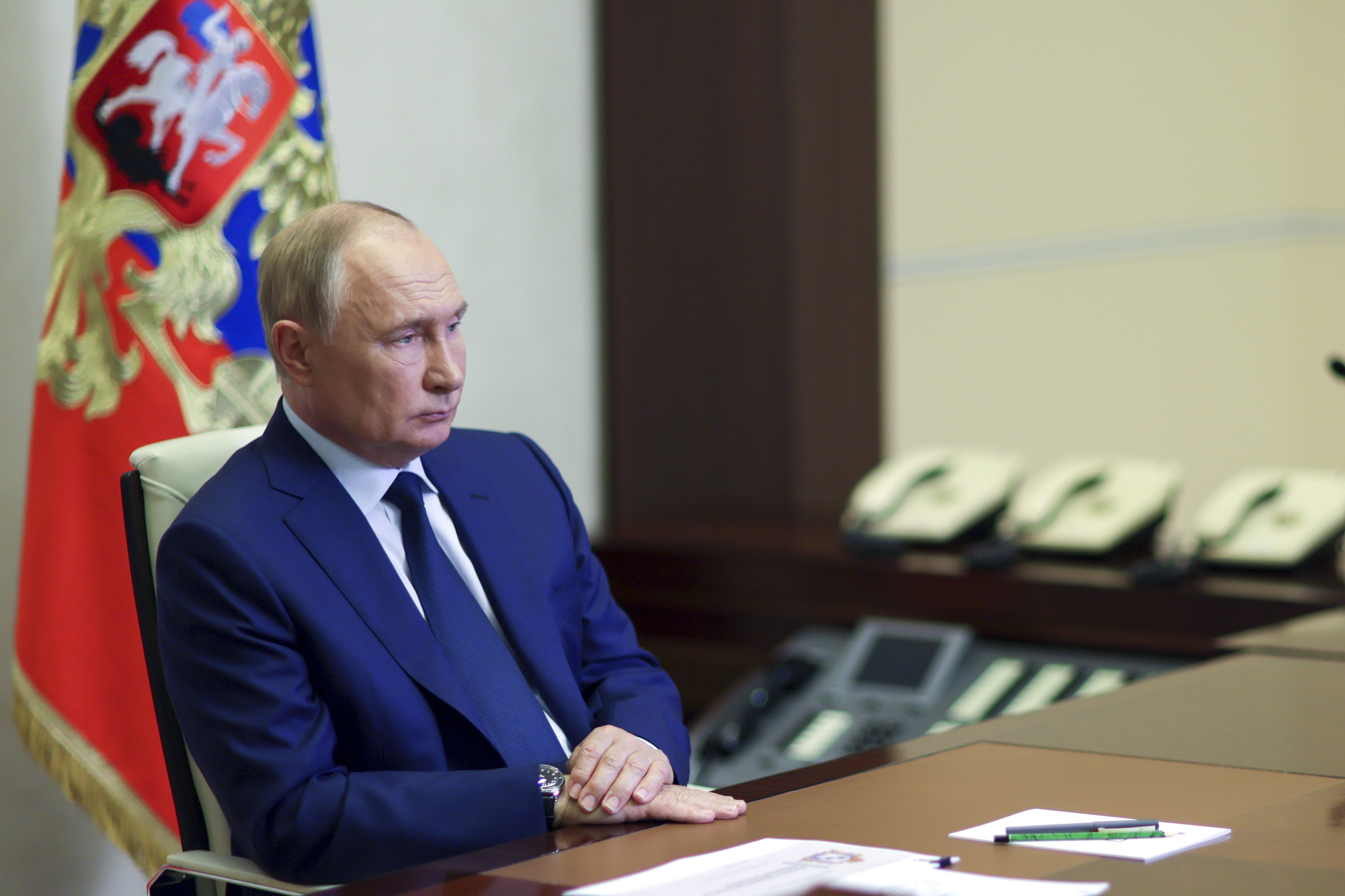 Russian President Vladimir Putin listens to acting Governor of Kursk region Alexei Smirnov