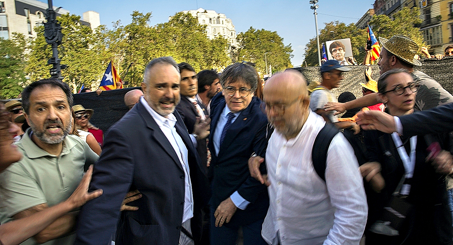 Catalan independence leader and former President Carles Puigdemont, center, arrives to address supporters.