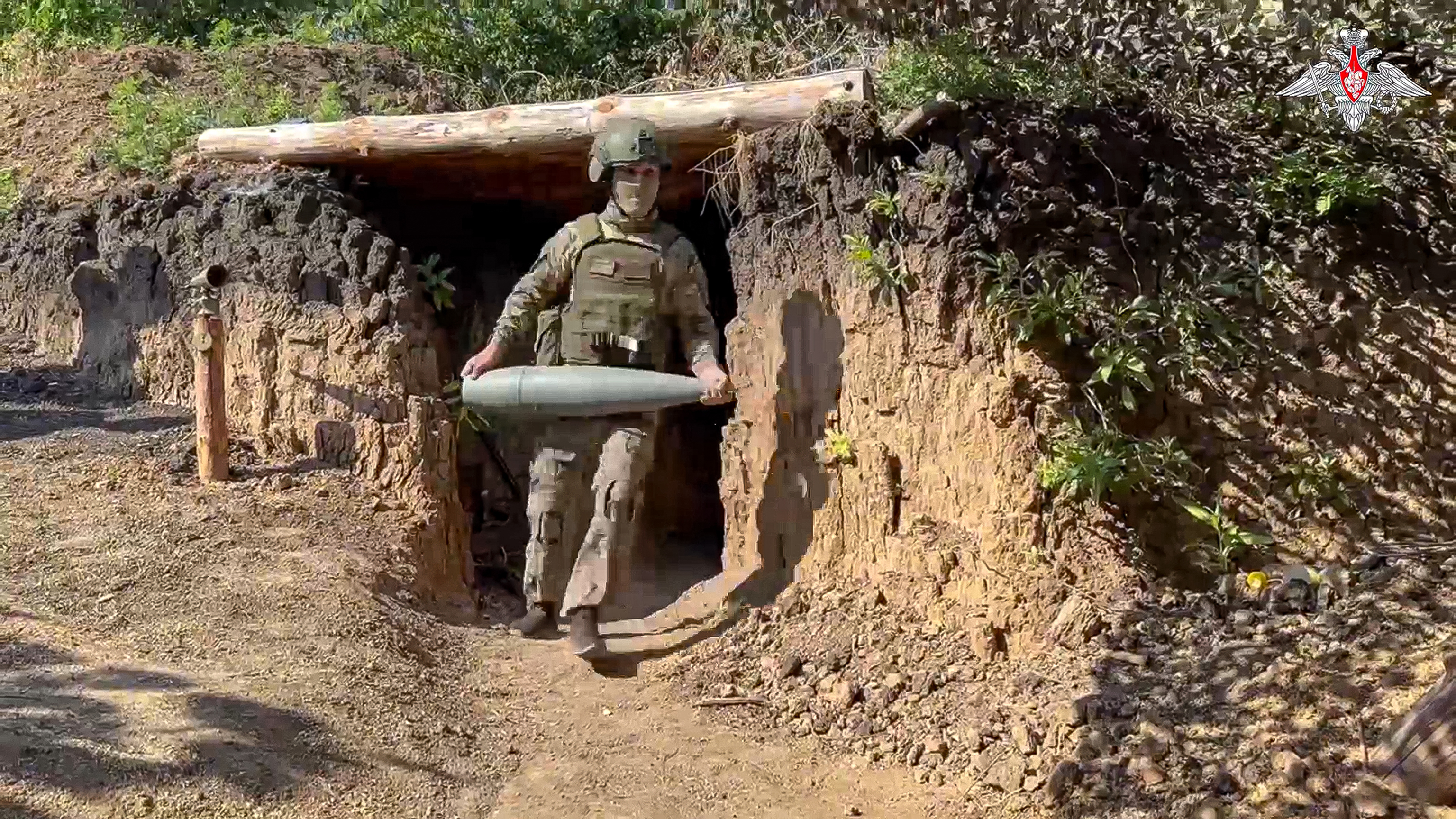 a Russian servicemen carries a shell for the 152mm howitzer