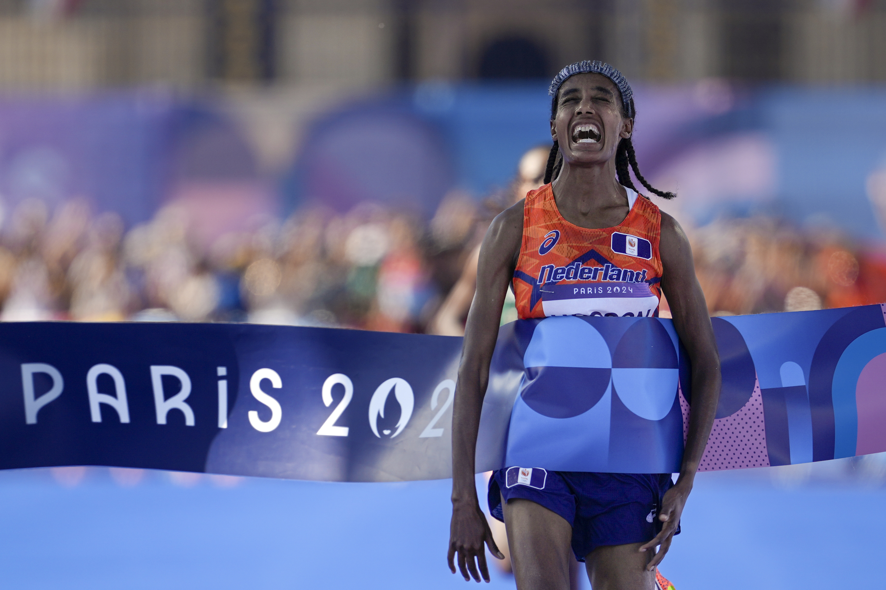 Sifan Hassan, of the Netherlands, celebrates after crossing the finish line to win the gold medal.