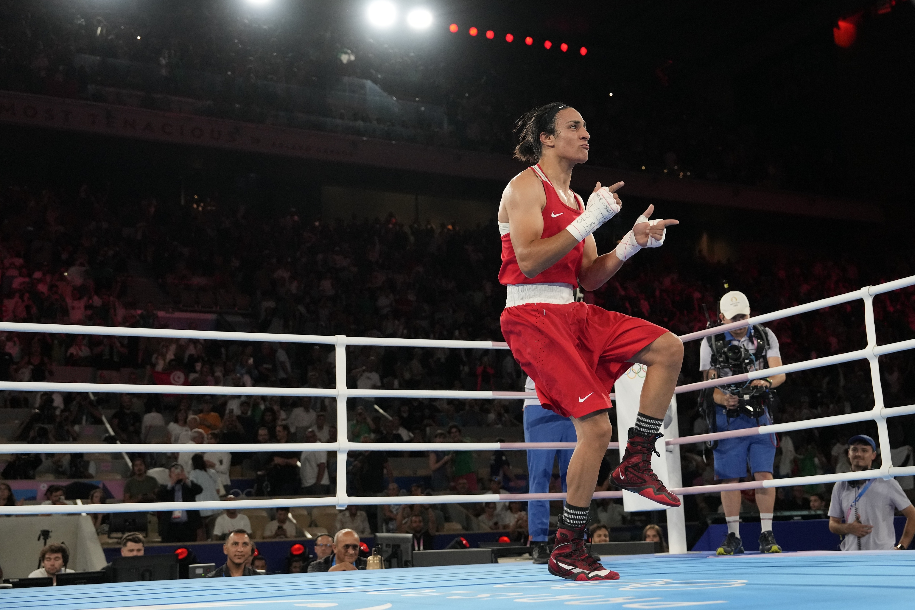 Algeria's Imane Khelif celebrates after defeating China's Yang Liu to win gold.