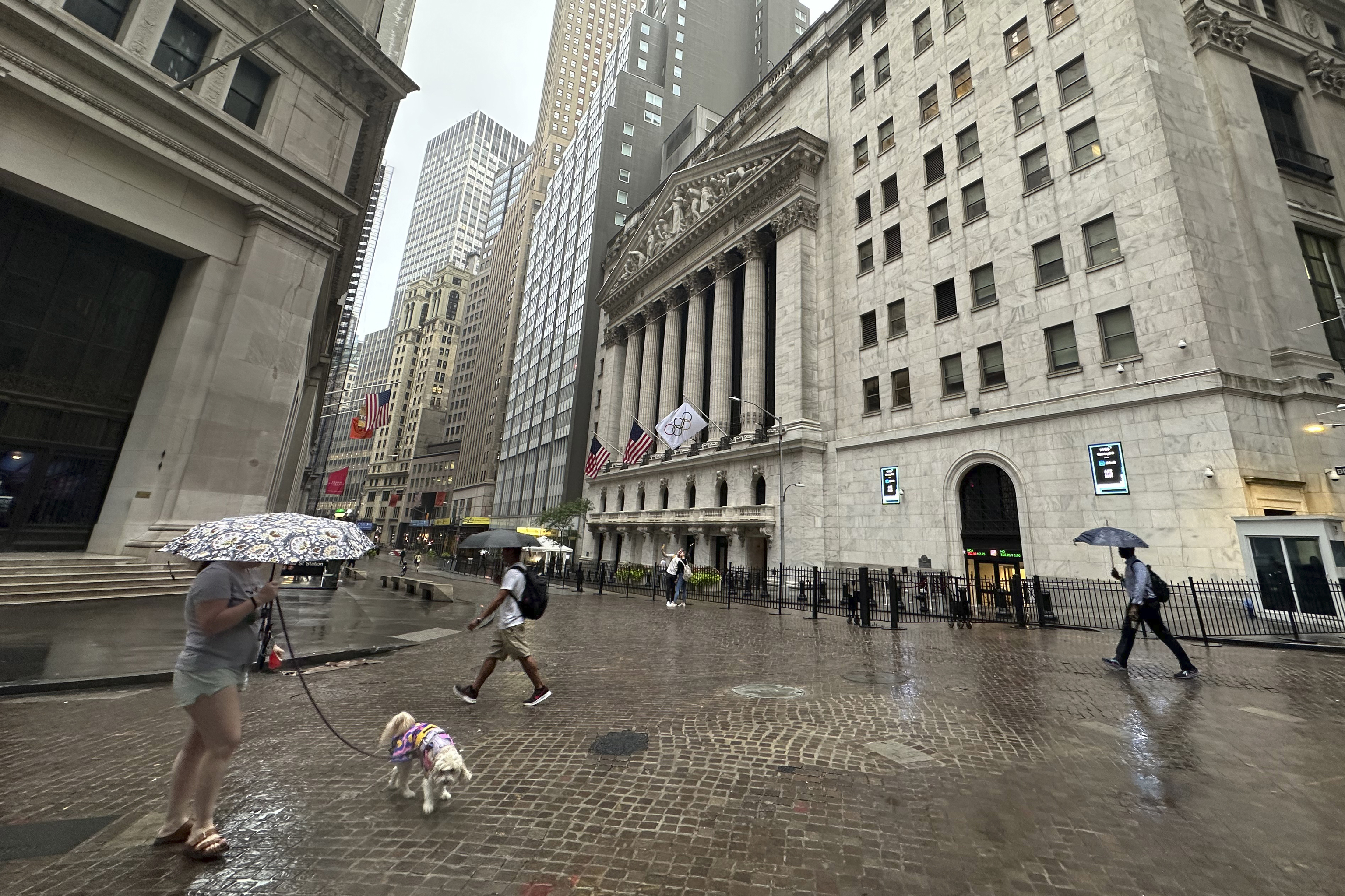 People walk past the New York Stock