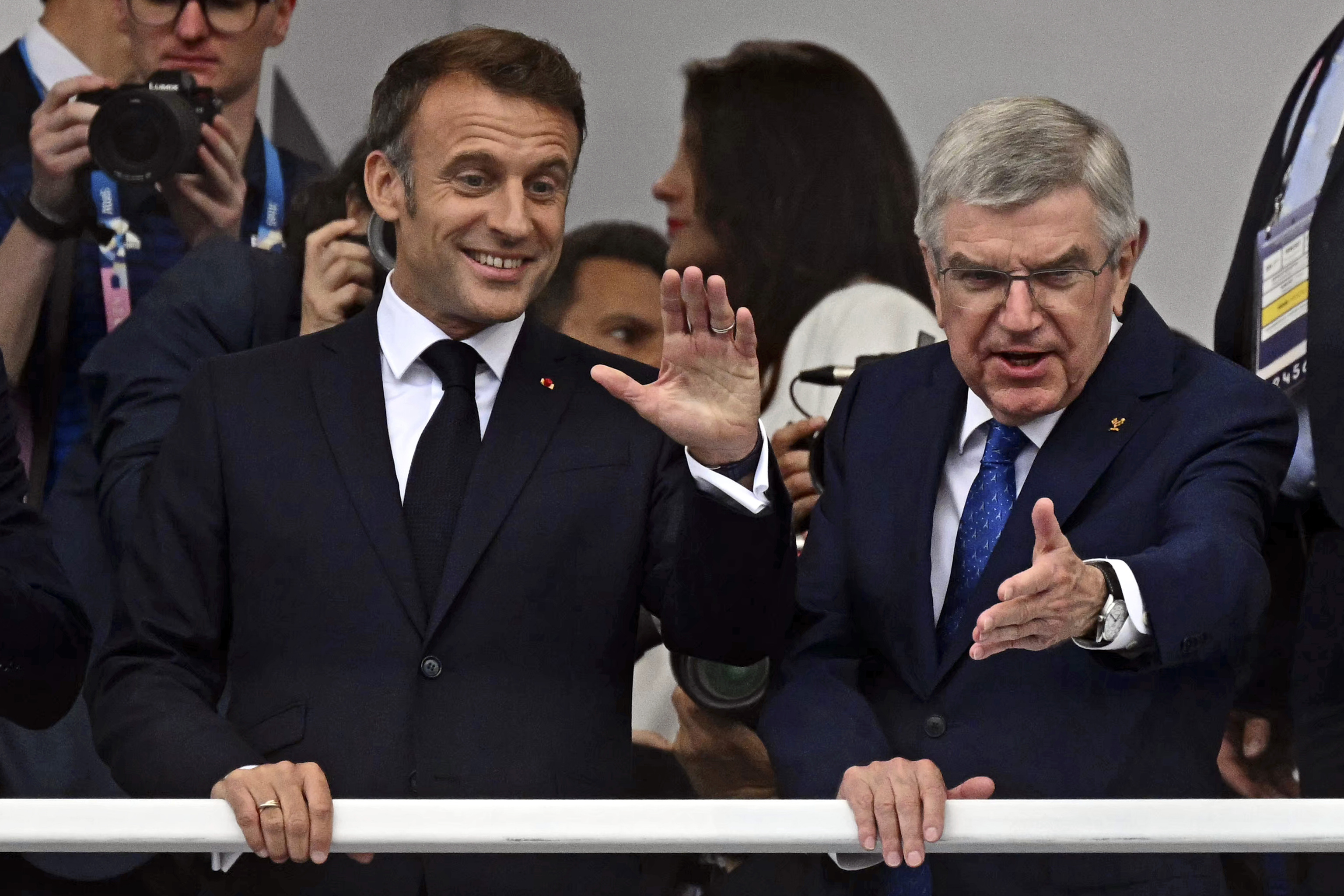 France's President Emmanuel Macron, left, and IOC President Thomas Bach.