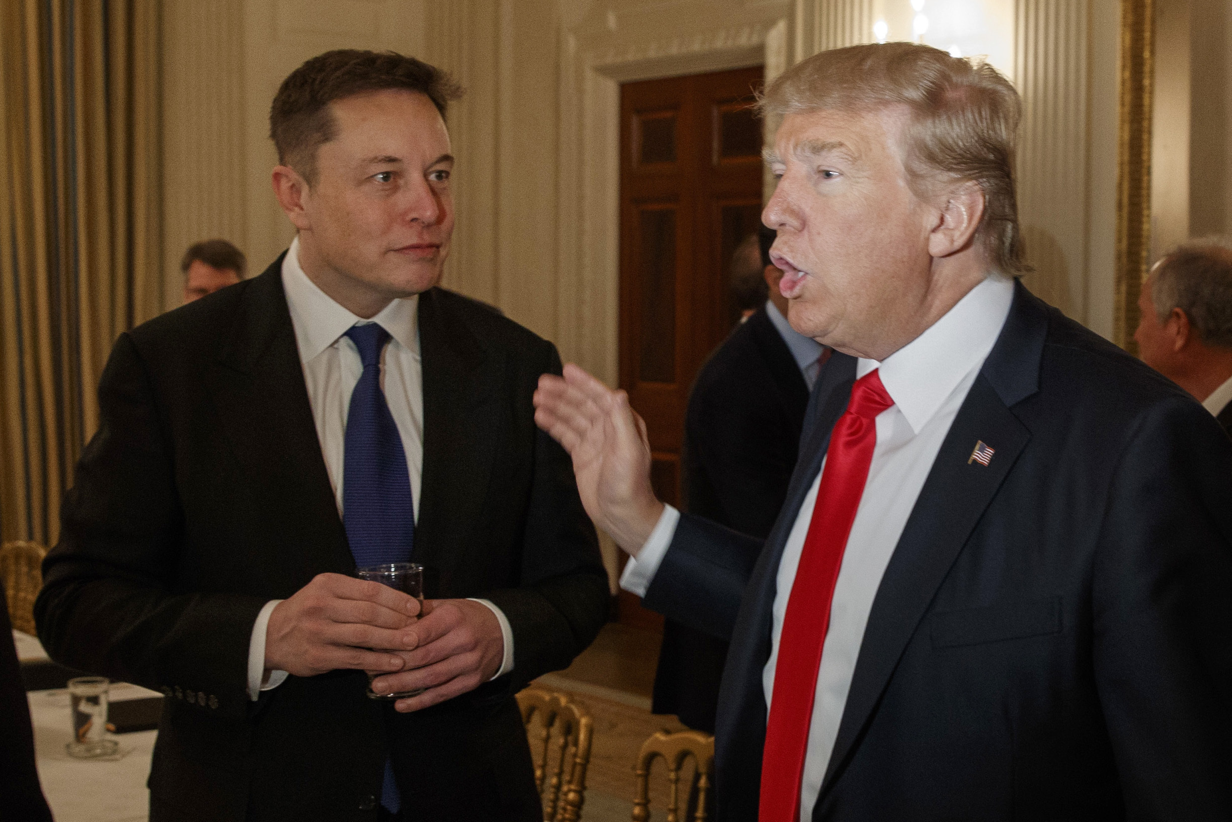 President Donald Trump, right, talks with Tesla and SpaceX CEO Elon Musk at the White House.