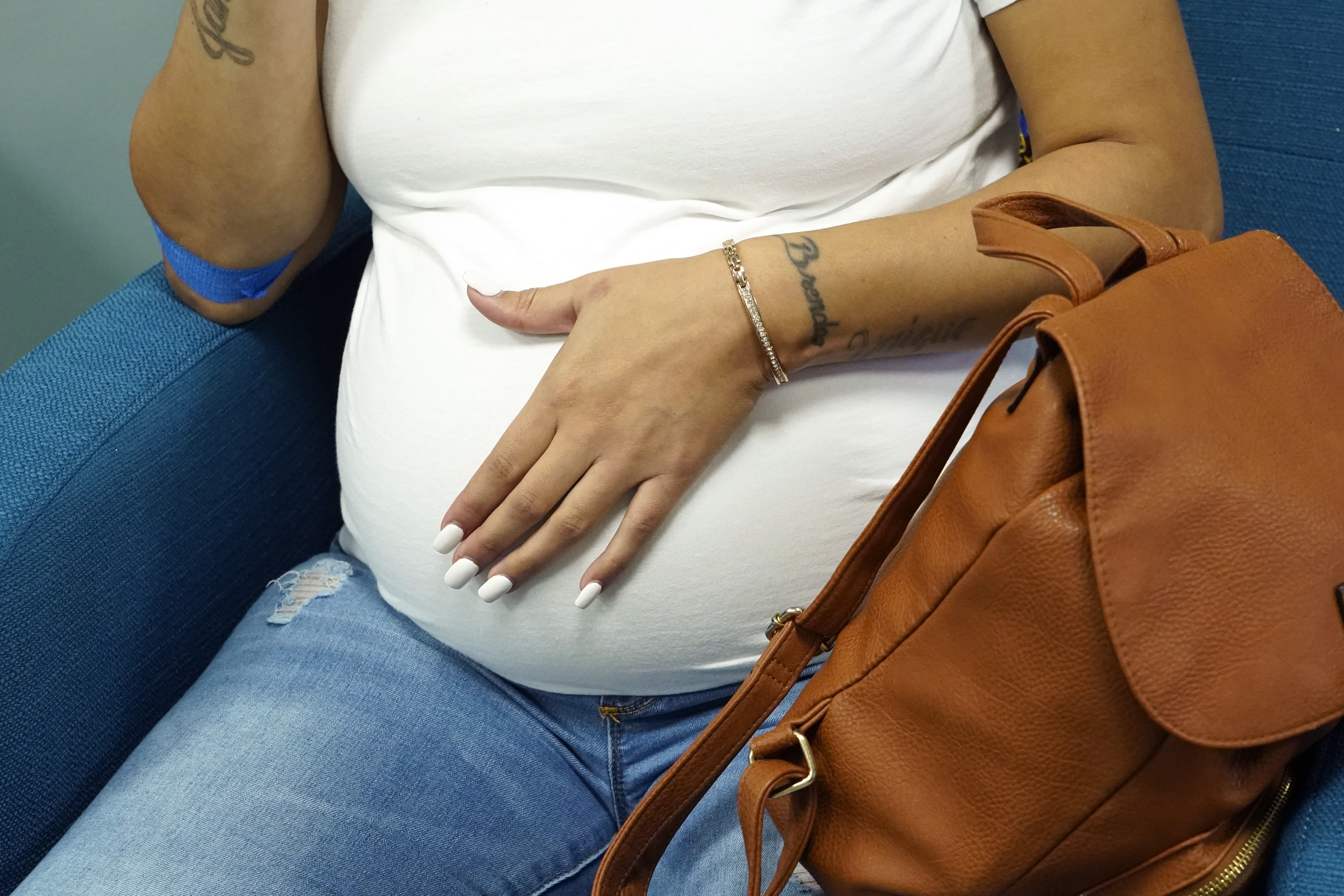 Miracle Allen rubs her stomach as she relaxes before meeting with the midwife at Sisters in Birth, a Jackson, Miss., clinic that serves pregnant women