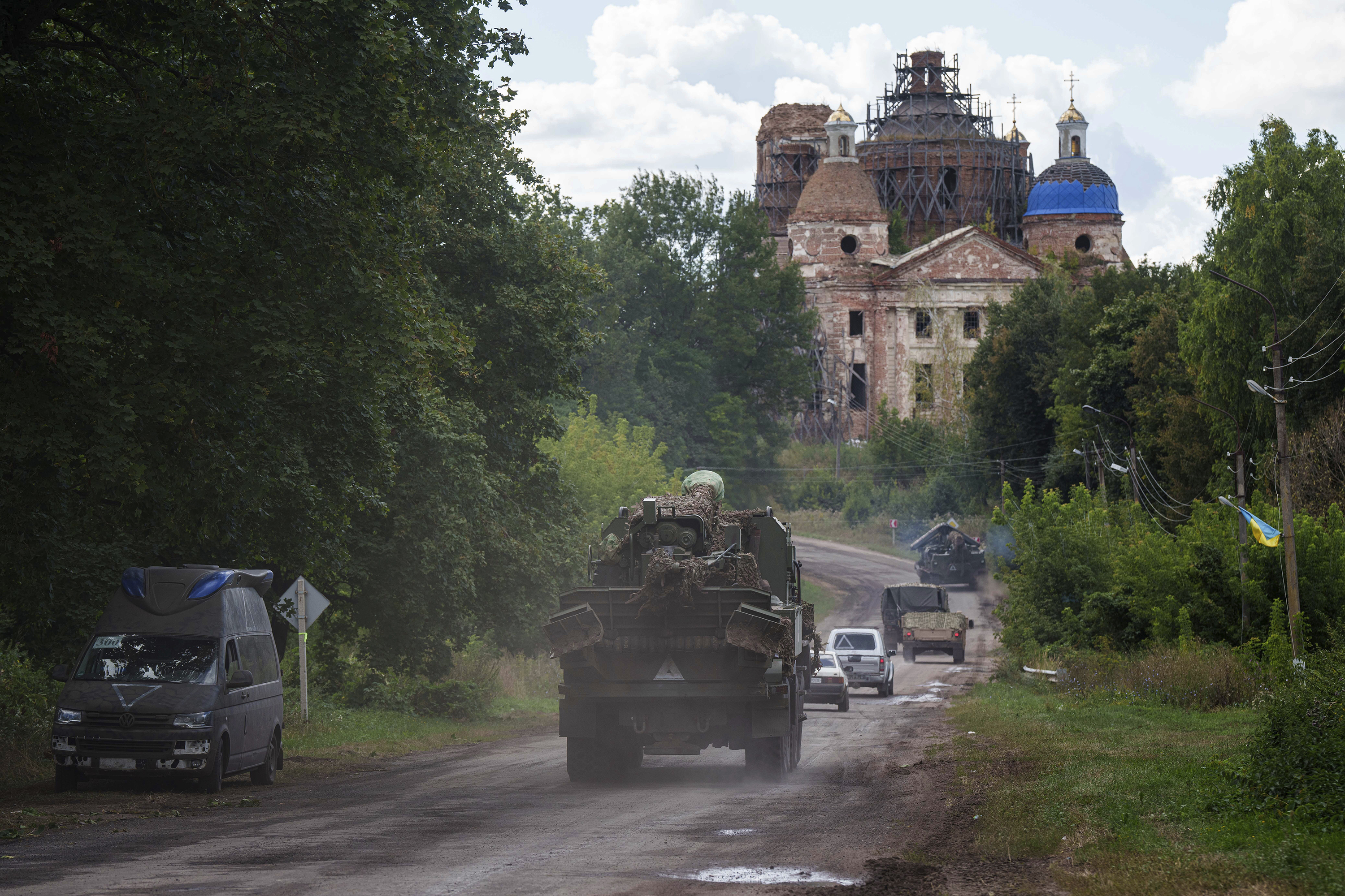 Military vehicles drive near the Russian-Ukrainian border in Sumy region