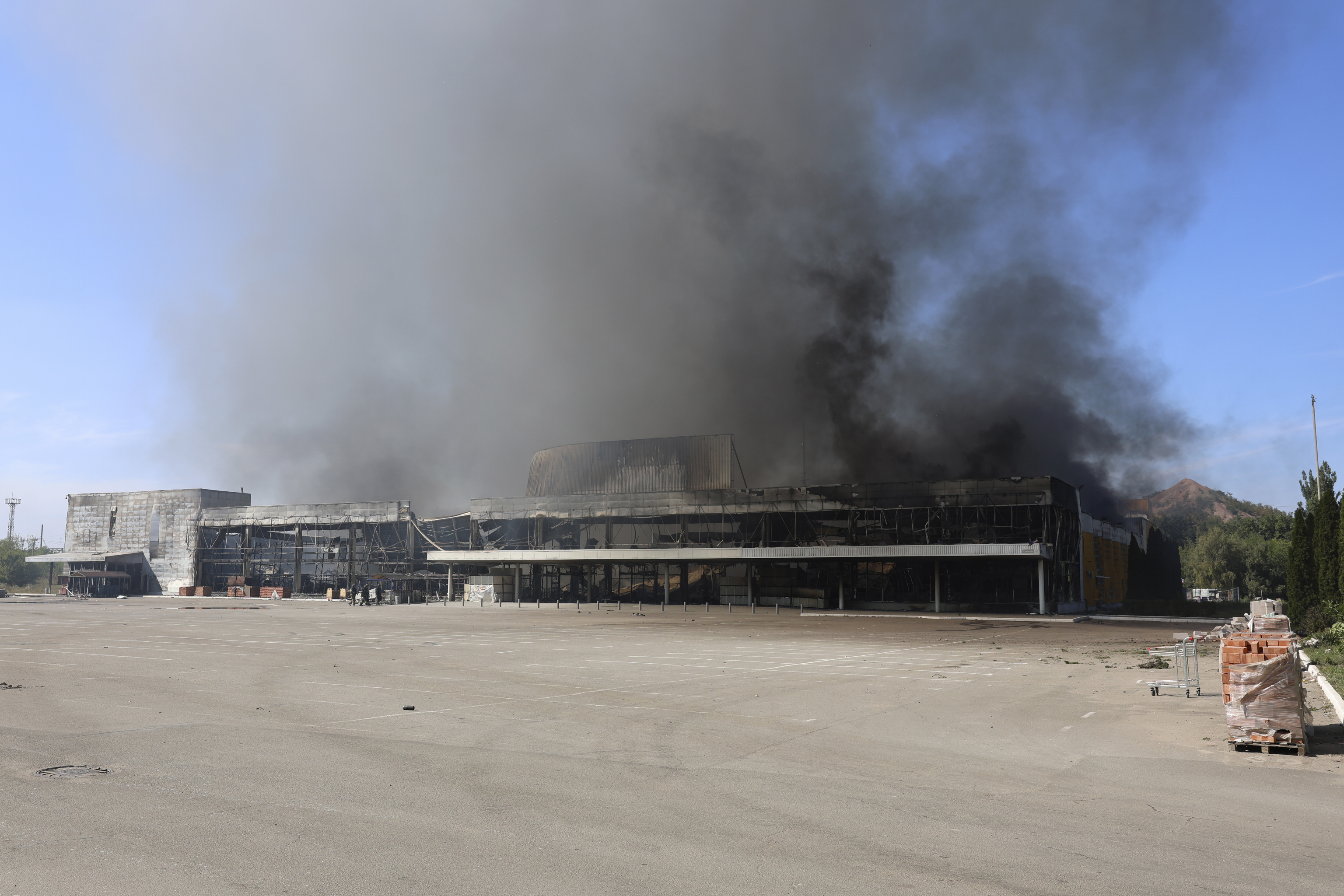 Smoke rises from a burned out shopping center after the shelling that Russian officials in Donetsk