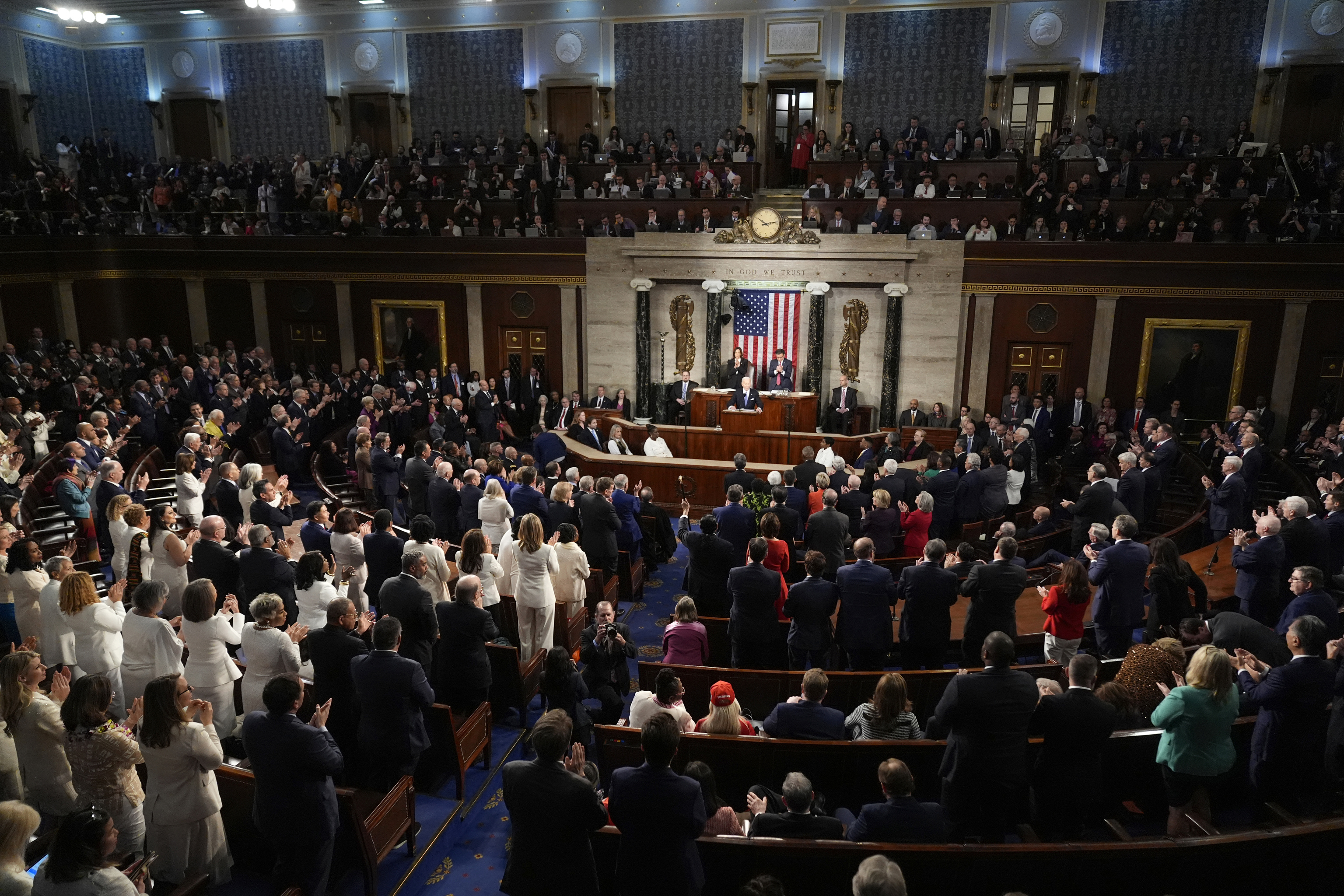 Both Democrats and Republicans stand to applaud as President Joe Biden speaks about former Rep. John Lewis