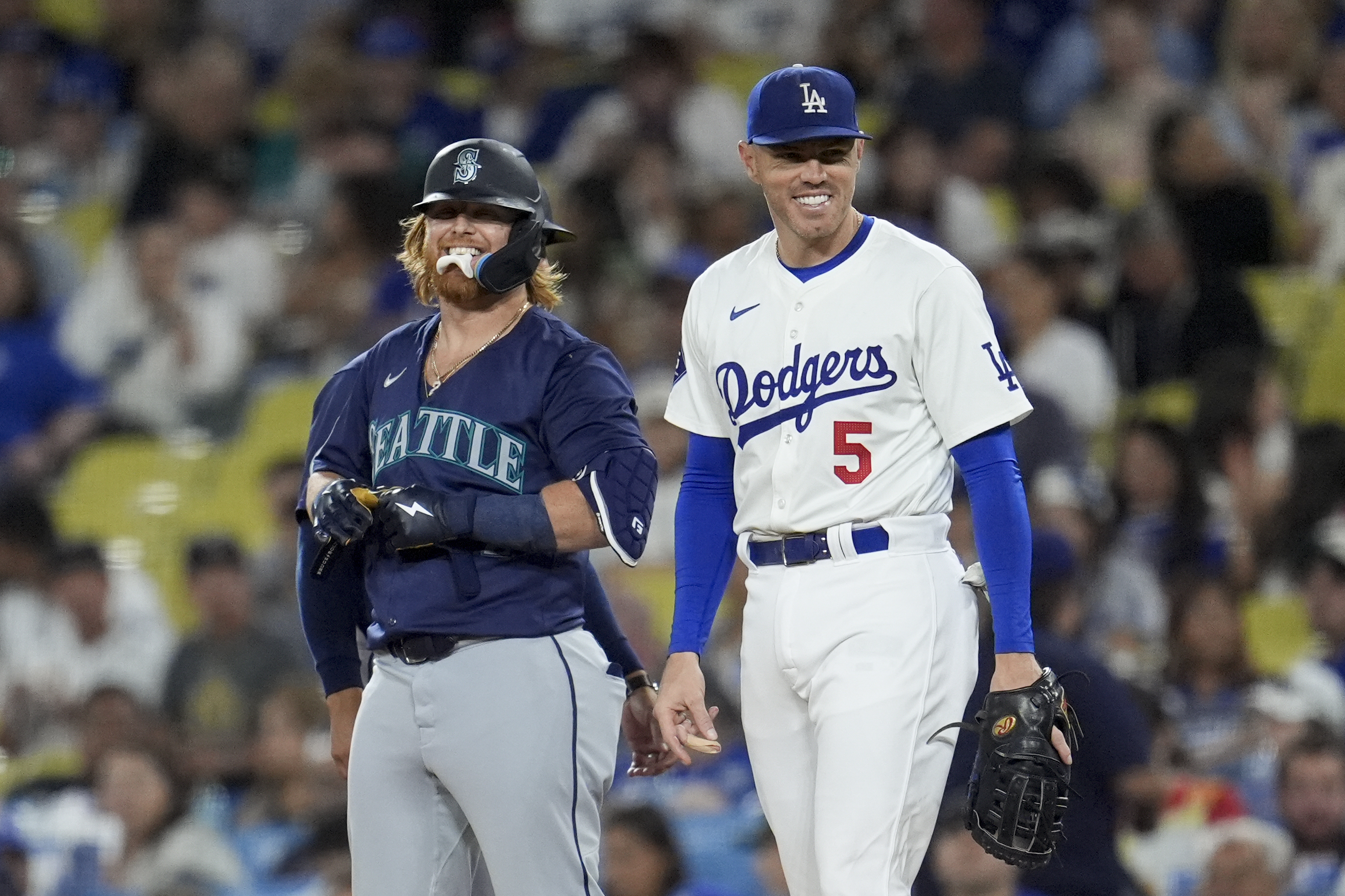 Seattle Mariners' Justin Turner, left, jokes with Los Angeles Dodgers first baseman Freddie Freeman