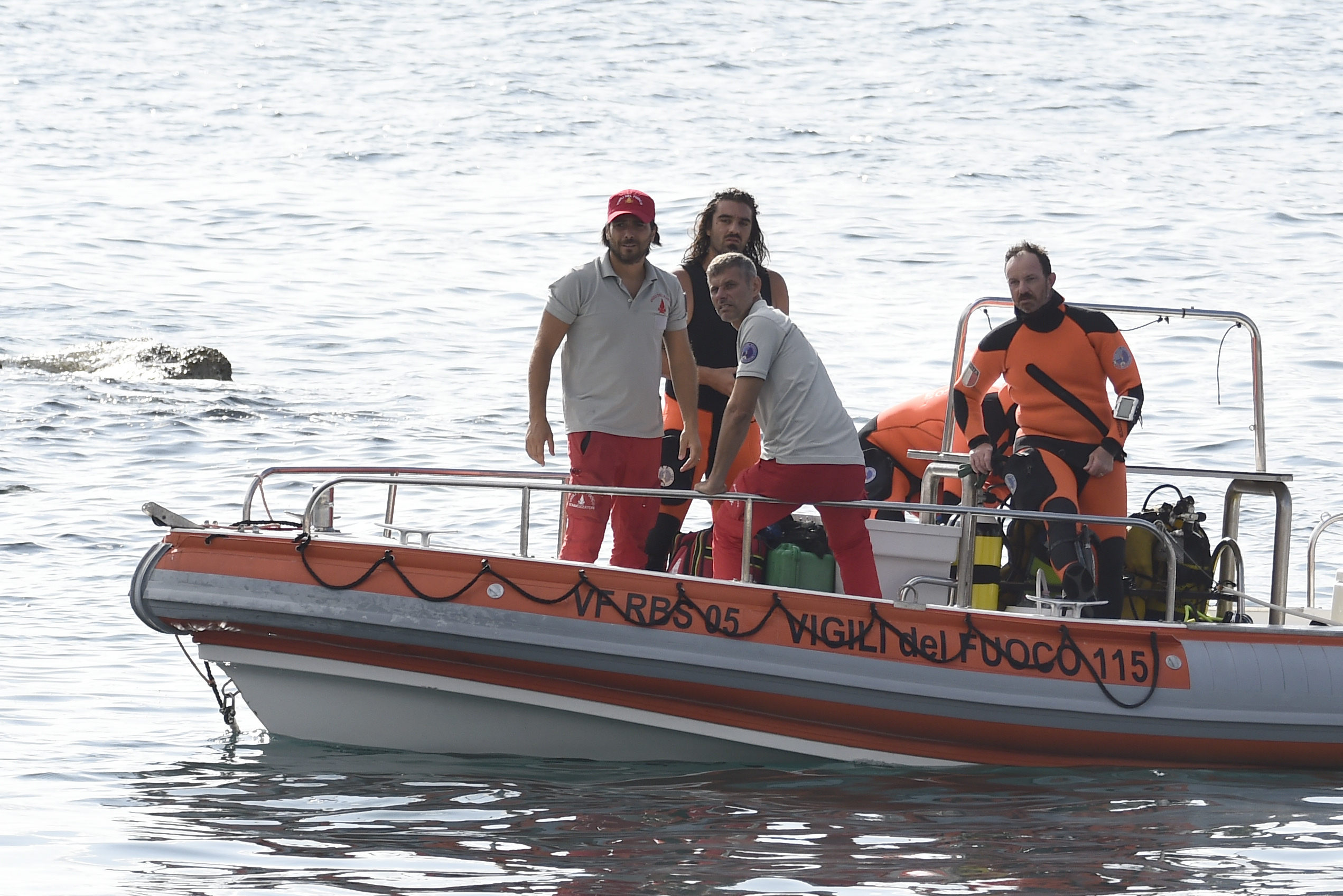 Italian firefighters scuba divers return to the harbor of Porticello, southern Italy